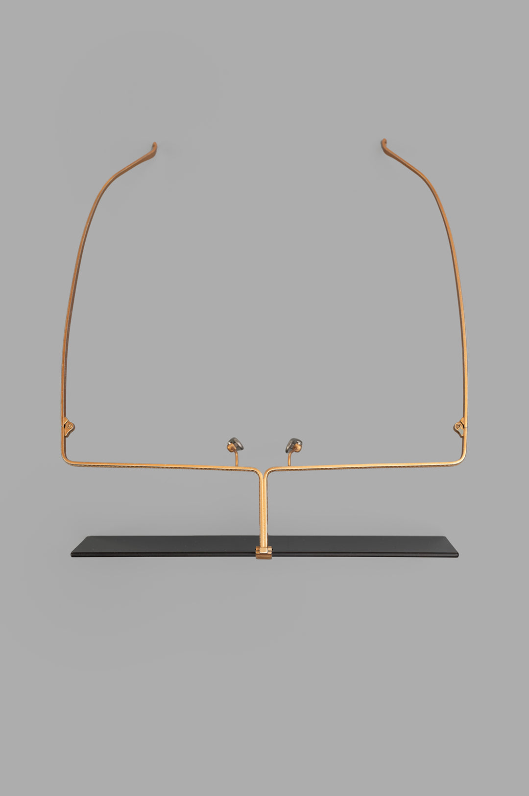 Uma Wang x Rigards Rectangular Glasses in gold on display, showcasing sleek titanium design and unique front view.