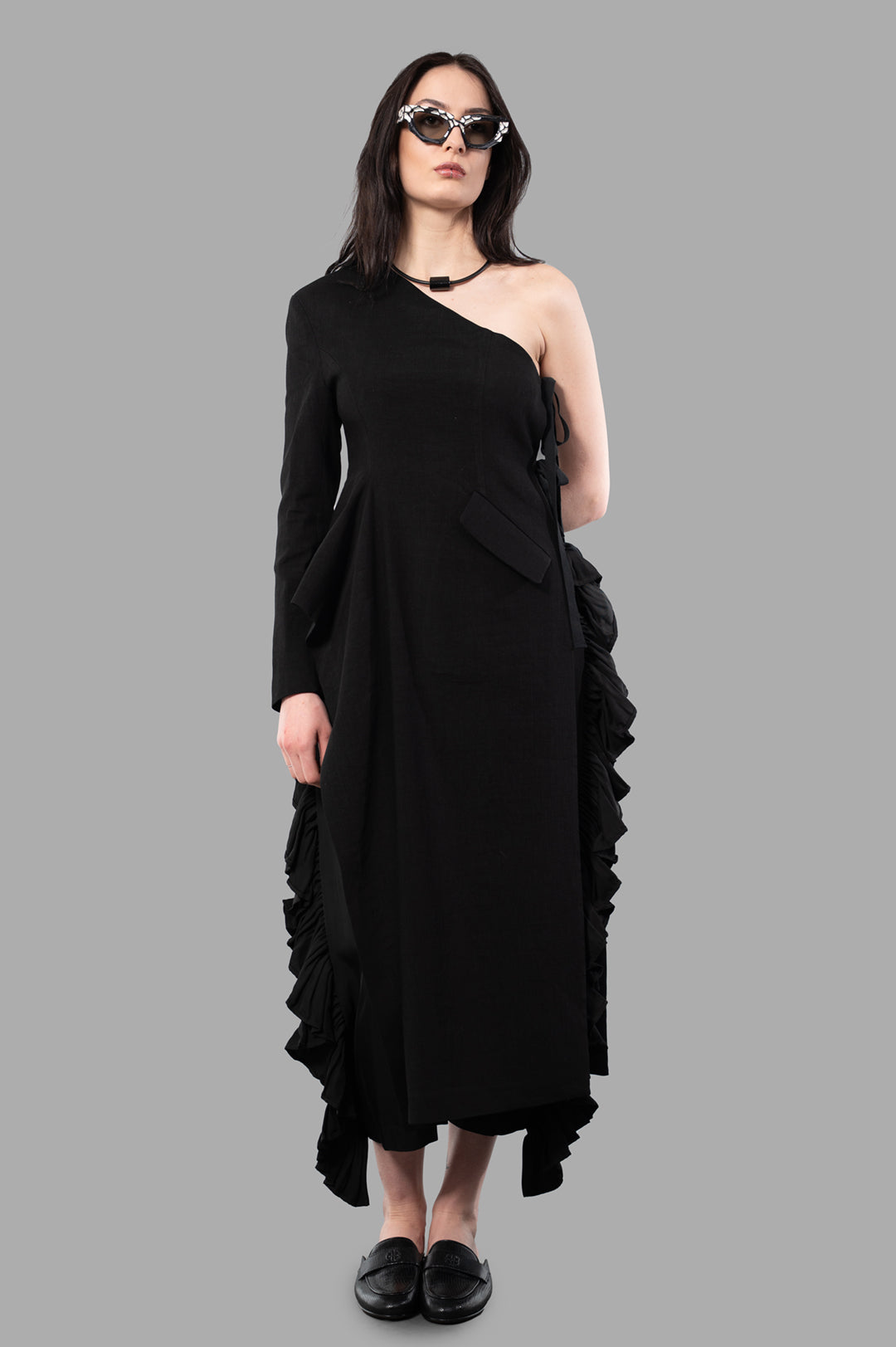 Uma Wang Asymmetric Coat on model, showing front view with one-shoulder design and ruffled detail, black color.