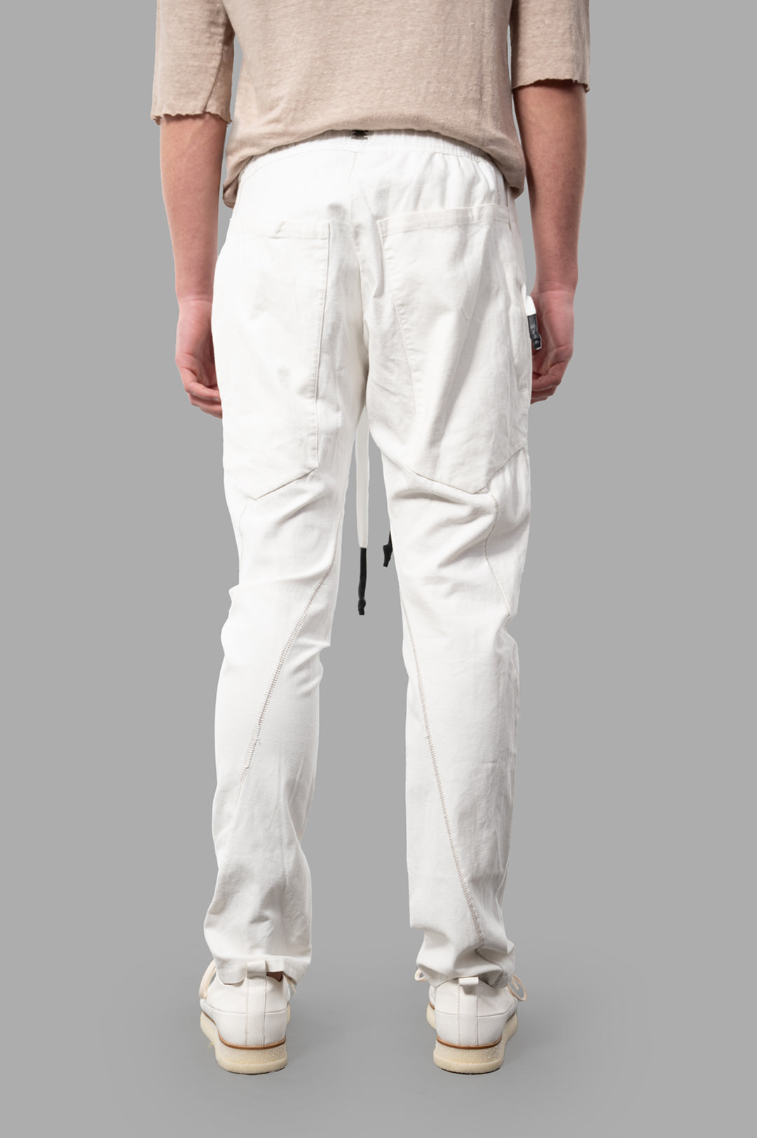 Isaac Sellam Drawstring Trousers in white, featuring back view with detailed stitching and elastic waistband.