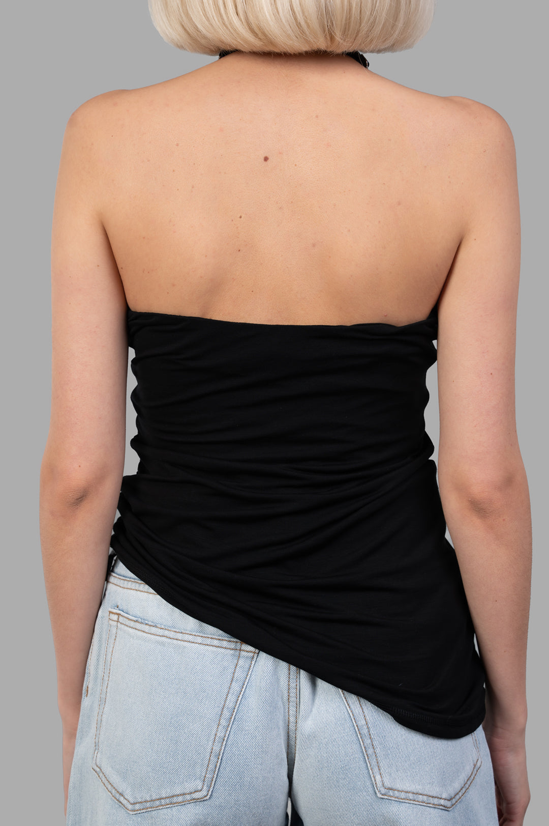 Helmut Lang Wind Harness Top in black, featuring a halter-neck and draped back design, made from soft lyocell jersey.