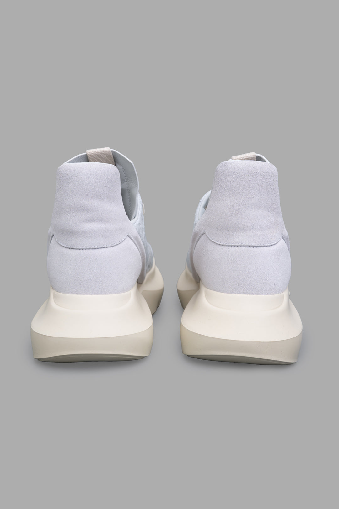 Rick Owens Hollywood Geth Runner in white, showcasing the cushioned back and geometric heel from a rear view.