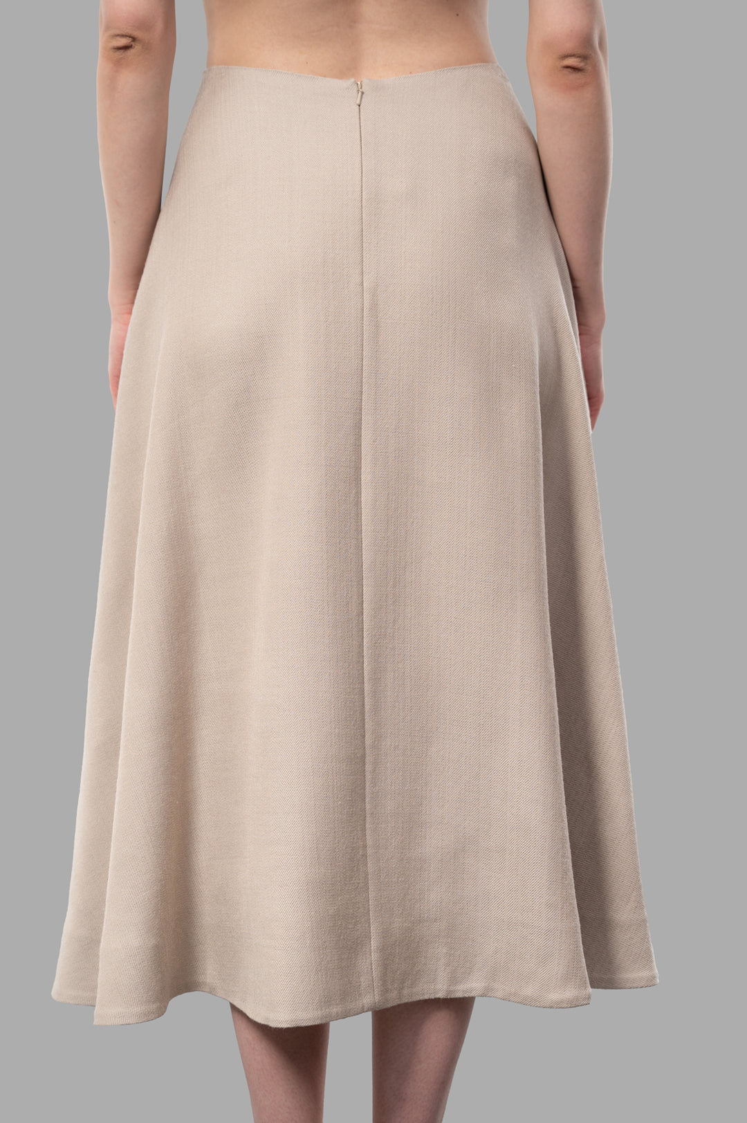 By Malene Birger Isella Midi Skirt shown from the back, featuring a neutral beige color and fluid texture in a classic.