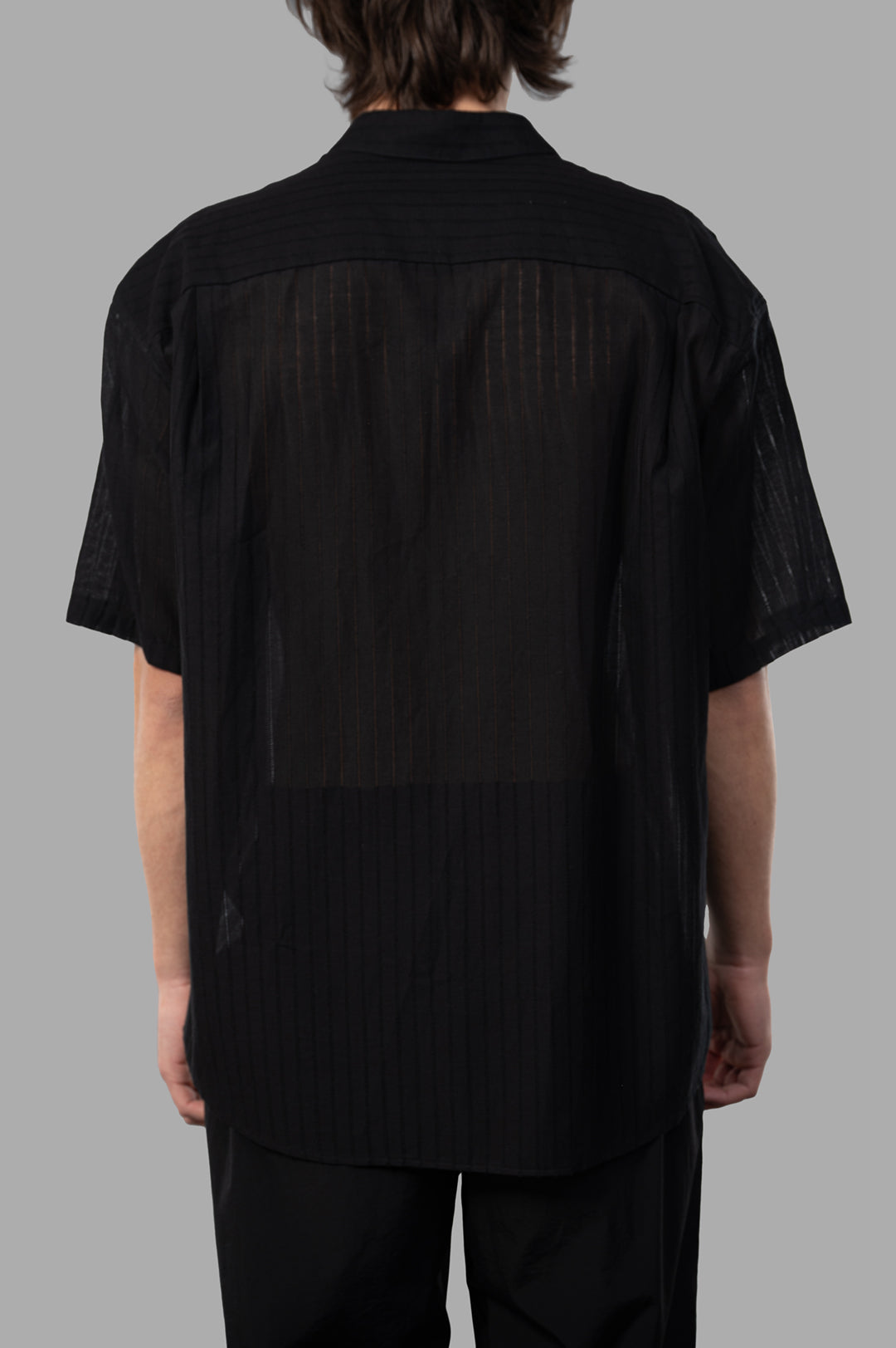 Attachment Textured Resort Shirt in black, showcasing a vertical striped texture from the back view, short sleeves visible.