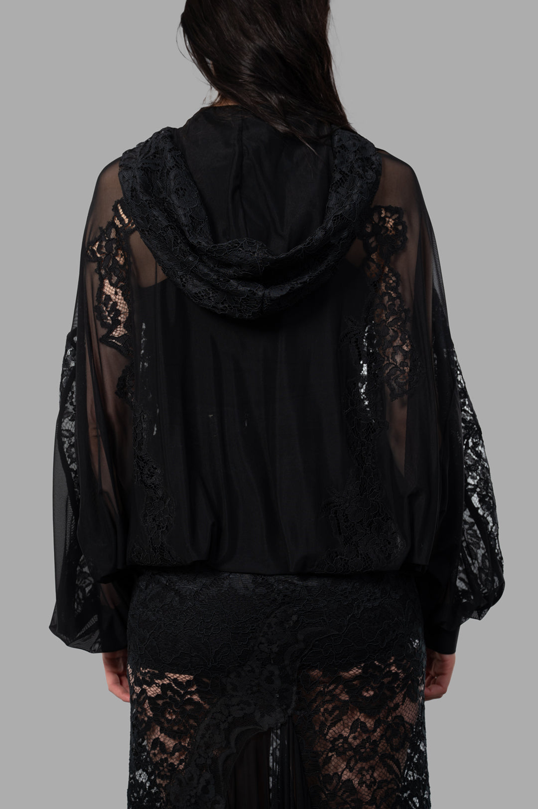 Sehnsucht Atelier Lace Hoodie in black, featuring intricate lace detailing, shown from the back on a model.