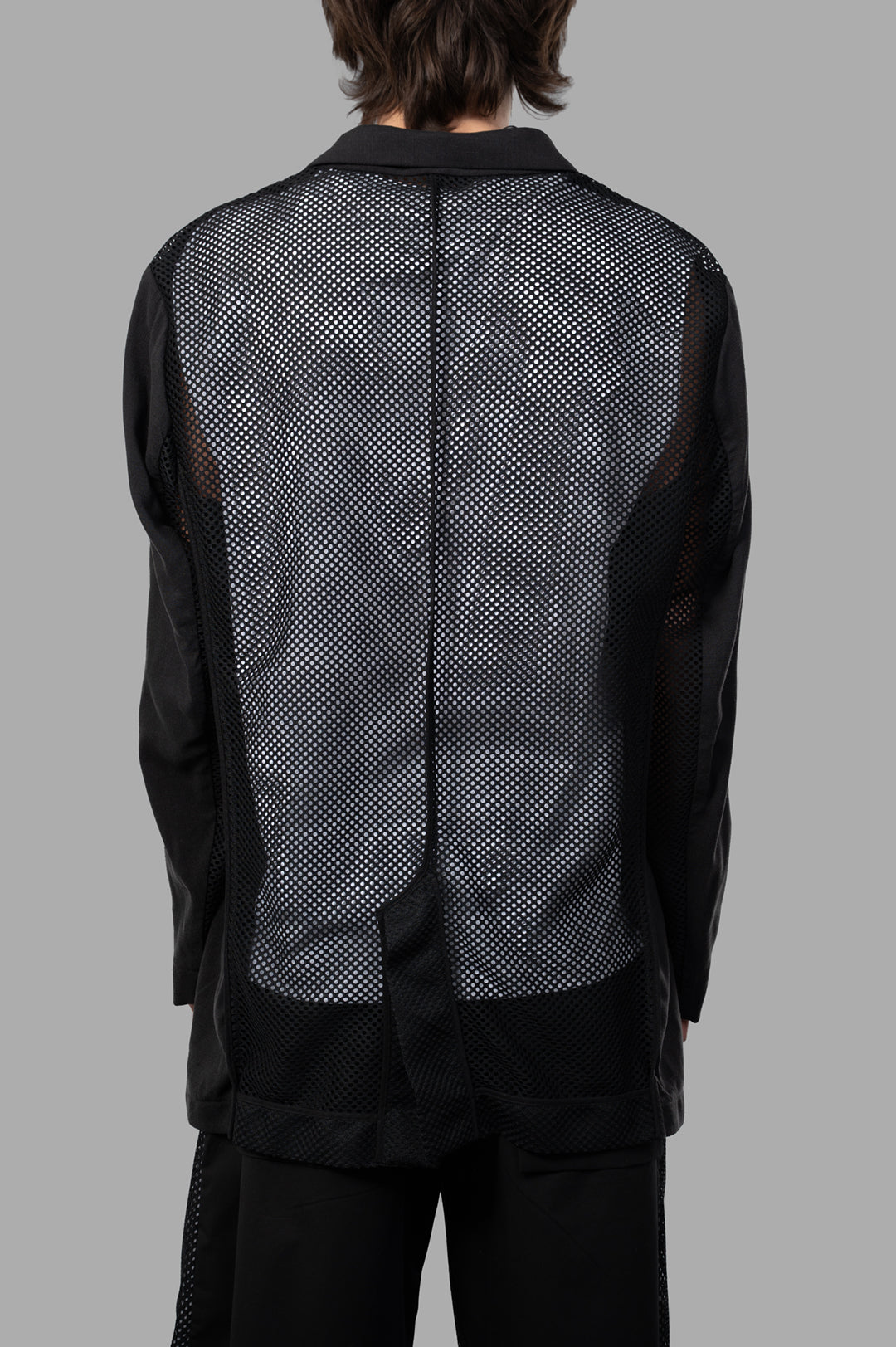 Giovanni Cavagna Semi-transparent Blazer showcasing the elegant back mesh detailing on a model, crafted from silk and.