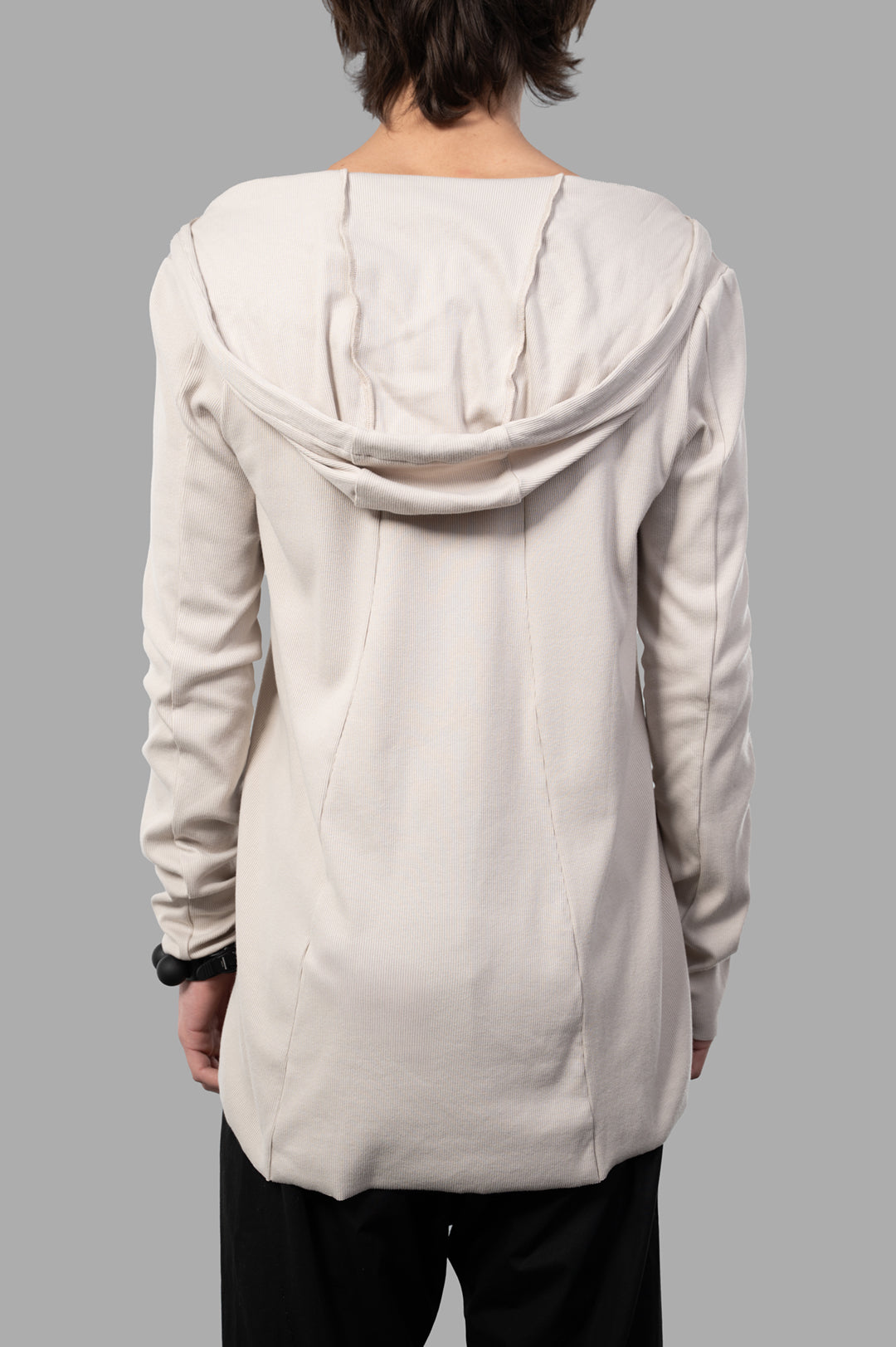 Justin Gall Light Rib Hooded Top shown from the back, featuring a soft beige bamboo-cotton blend with draped hood.
