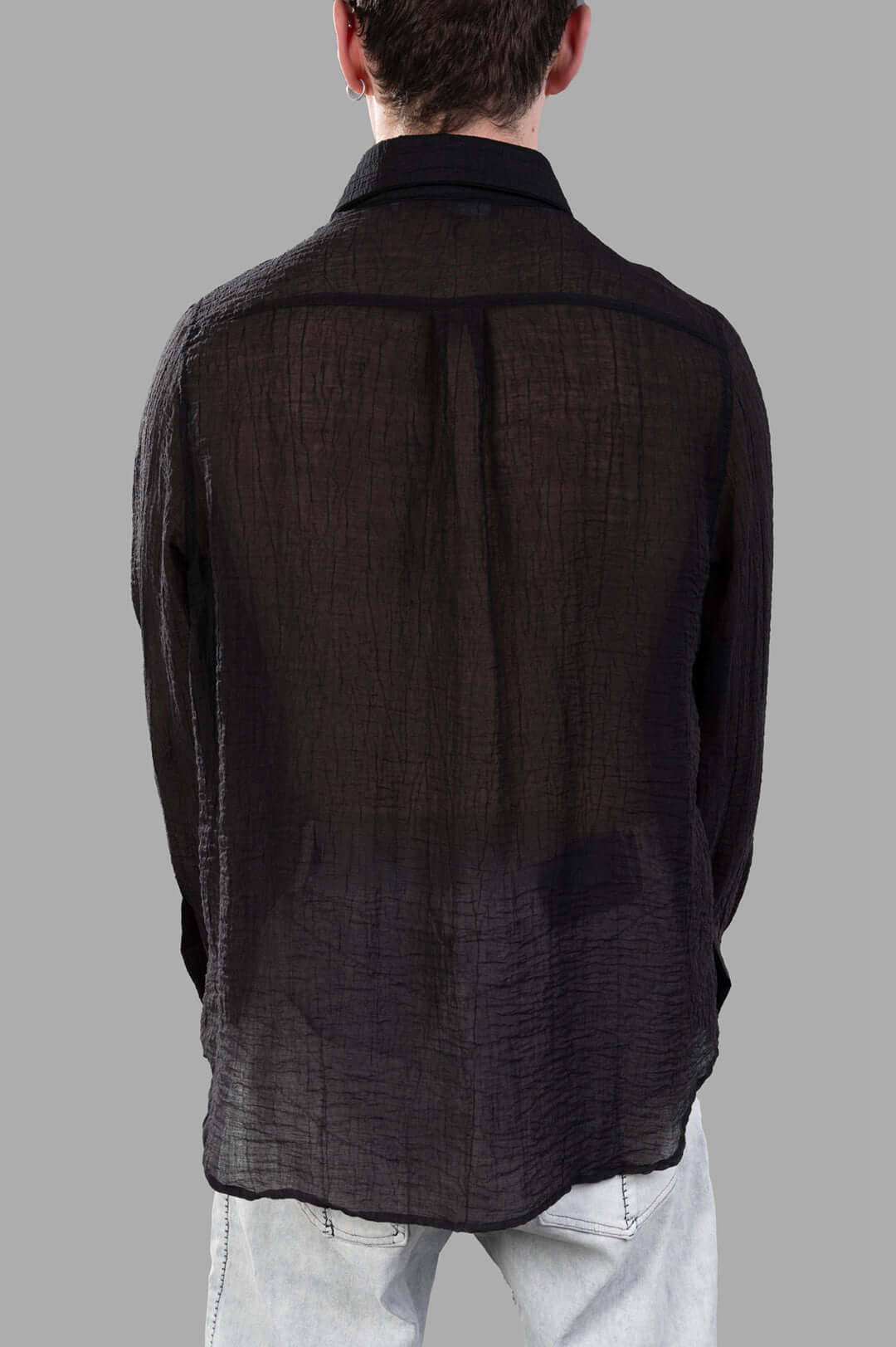 Justin Gall Crinkled Shirt seen from behind, featuring a semi-transparent texture and relaxed-fit silhouette in black.