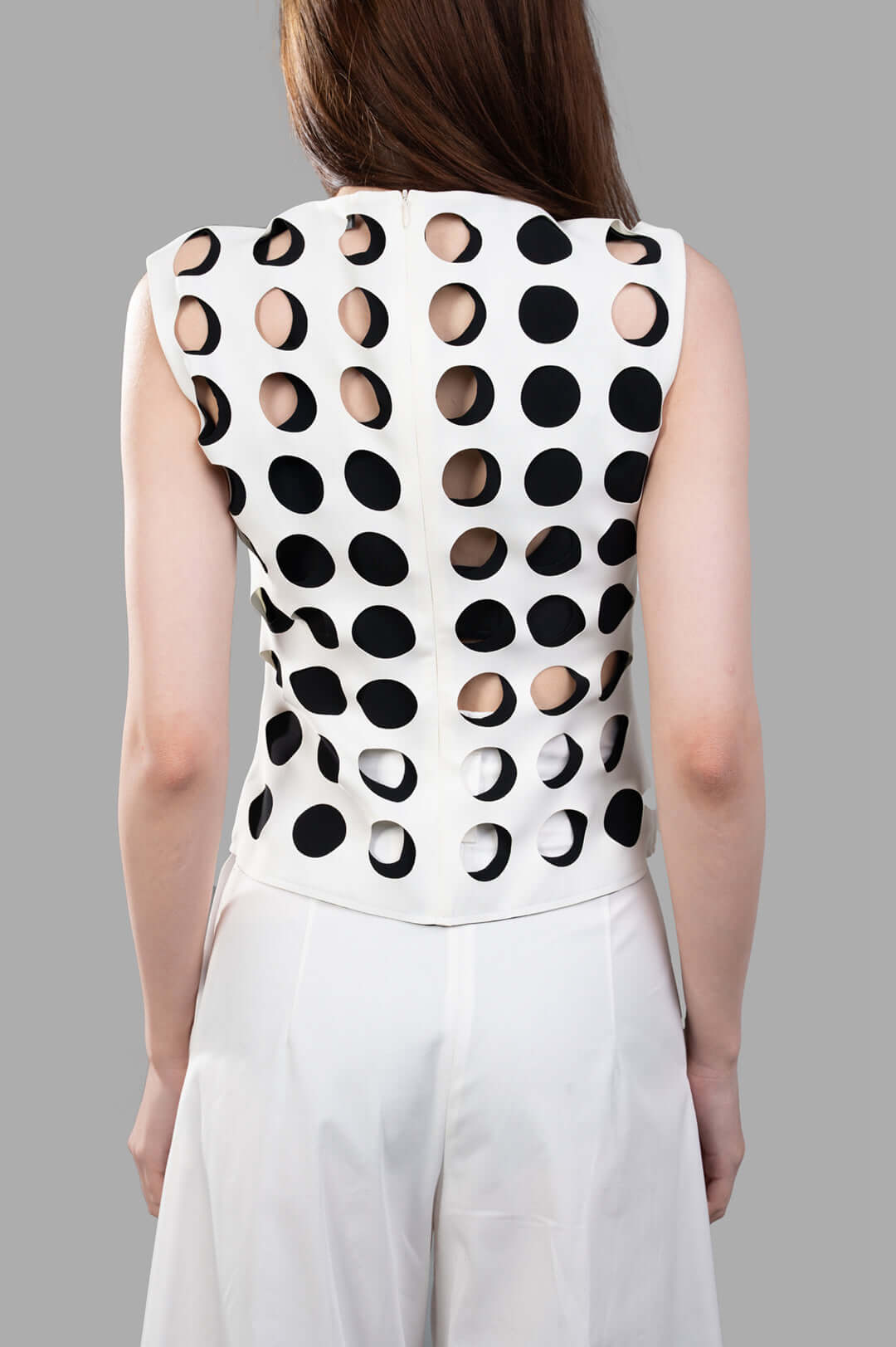 A.W.A.K.E. MODE Top with Layered Holes, showing back view with layered cut-out detailing on a white slim silhouette design.