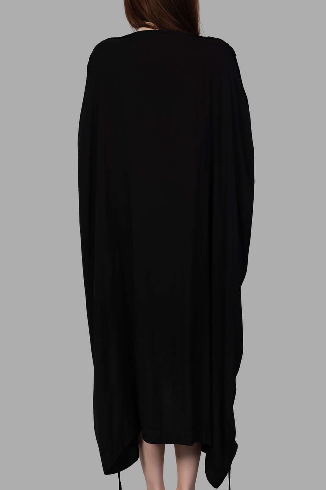 Isaac Sellam. Leather-detail Dress showcased from the back, featuring flowing fabric and sleek high-low design in black.