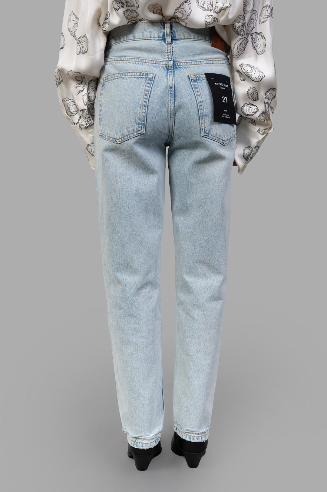 Anine Bing Kate Jeans shown from the back, featuring a bleached blue wash and vintage-inspired details. 100% cotton denim.