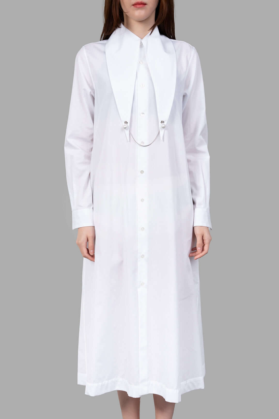 Noir Kei Ninomiya Charm-collar Shirt Dress in white, showcasing an exaggerated collar with pearl charm detailing.