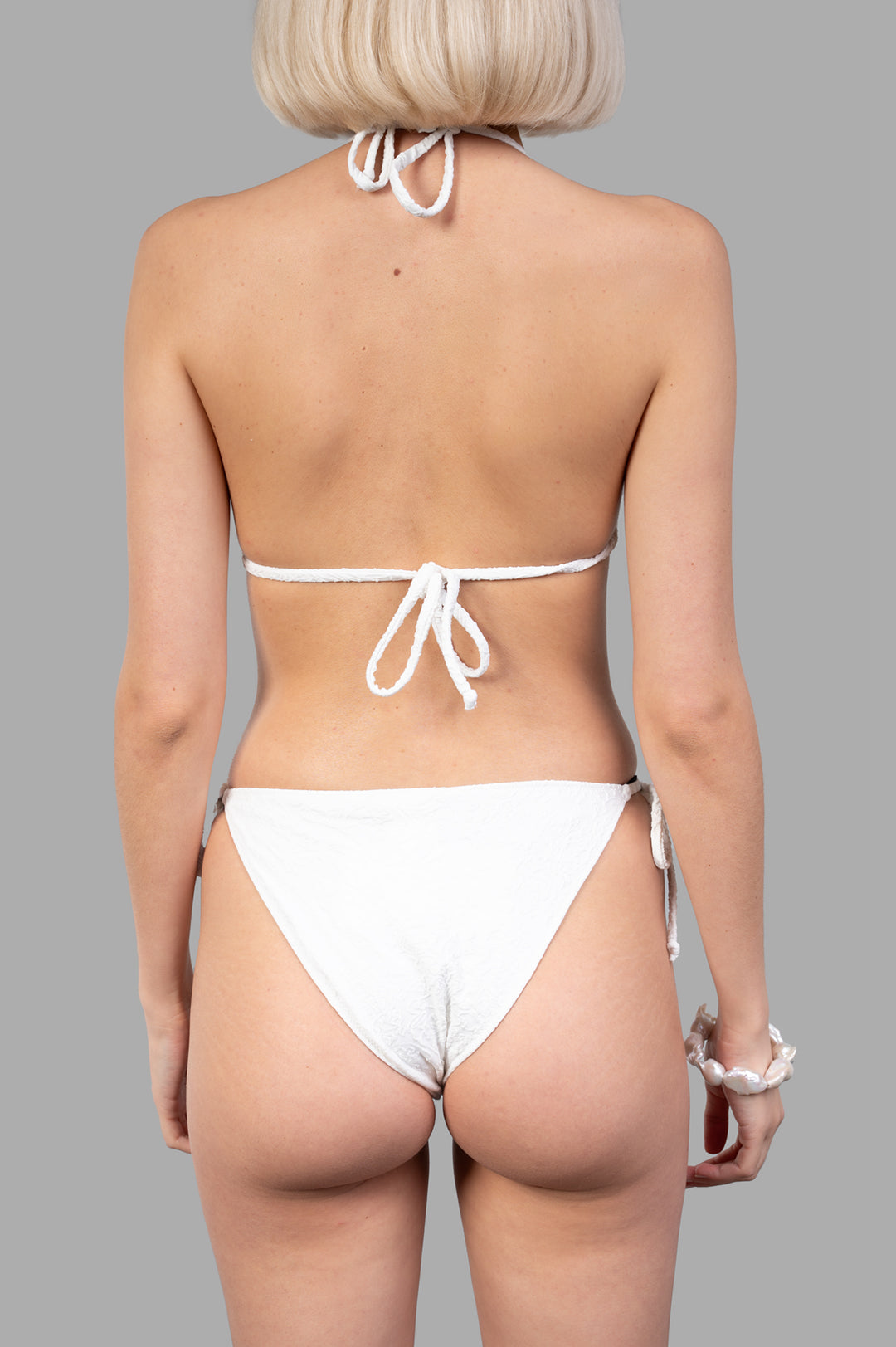 Anjuna Paisley Textured Bikini Set seen from the back, featuring delicate ties and a sophisticated white texture.