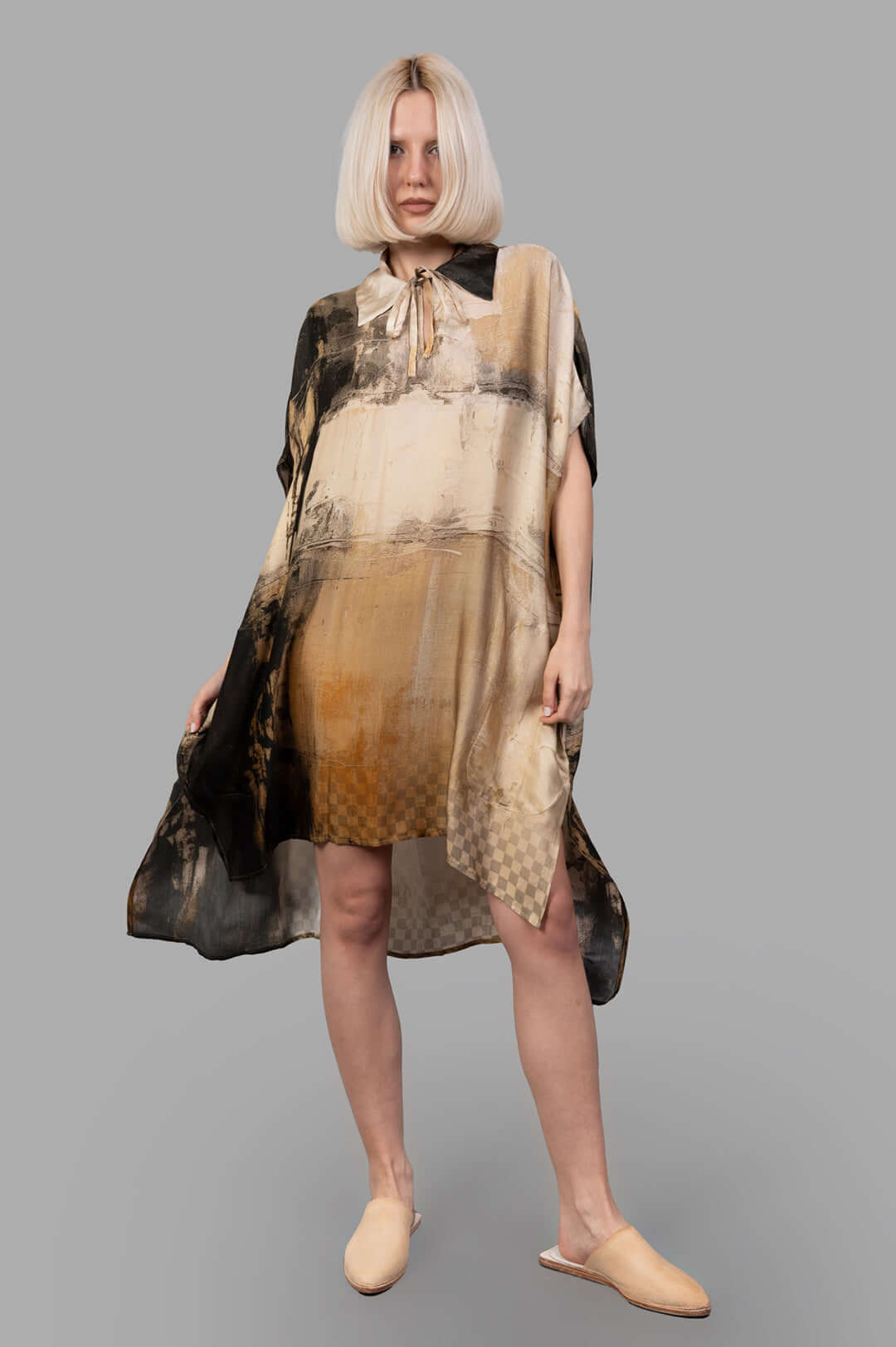 Masnada Abstract-print Dress on-model front view, tie-neck kaftan silhouette in beige-black with side slits and asym hem