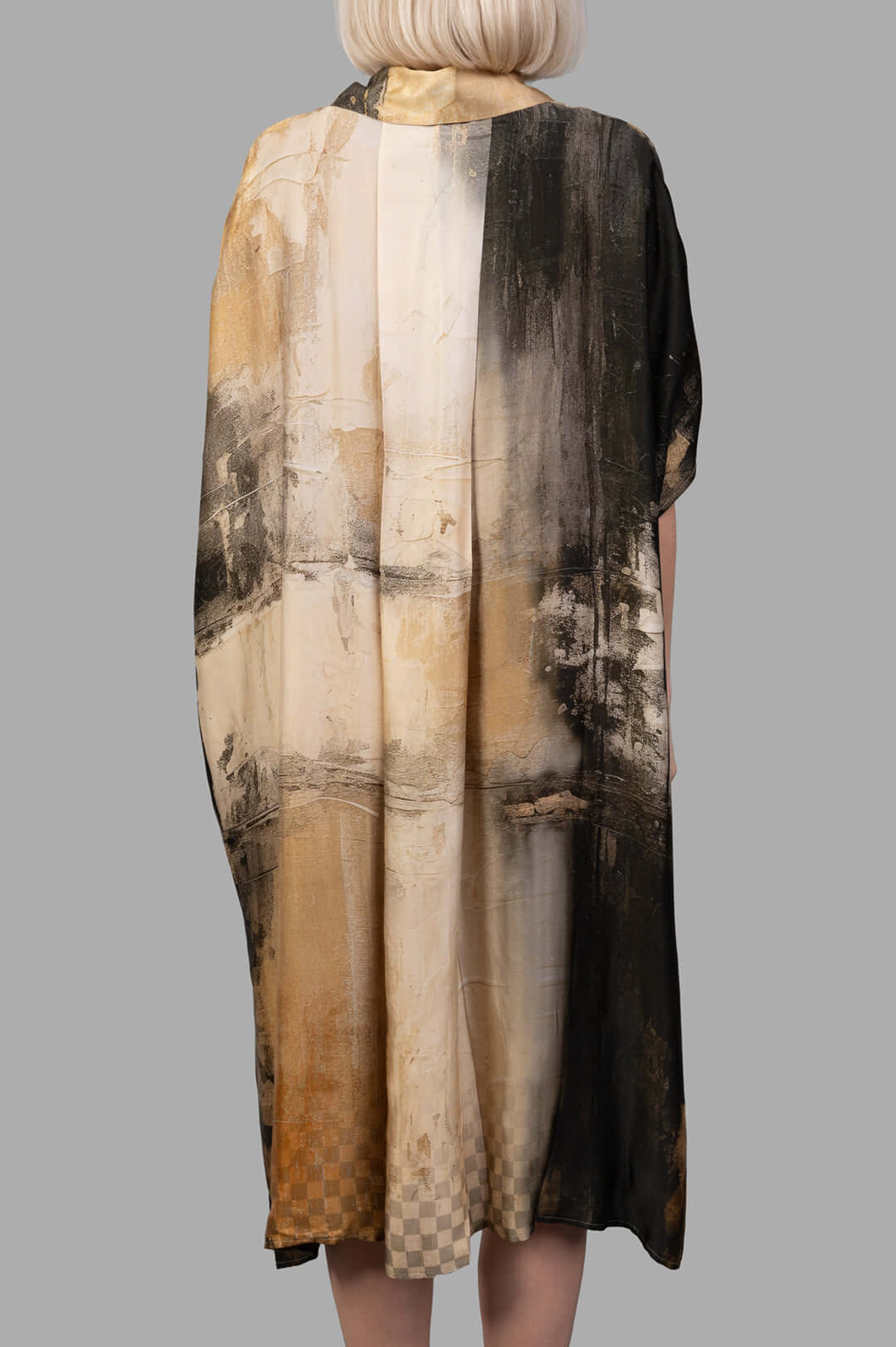 Masnada Abstract-print Dress showcased from the back, featuring an artistic blend of earthy tones and textures.