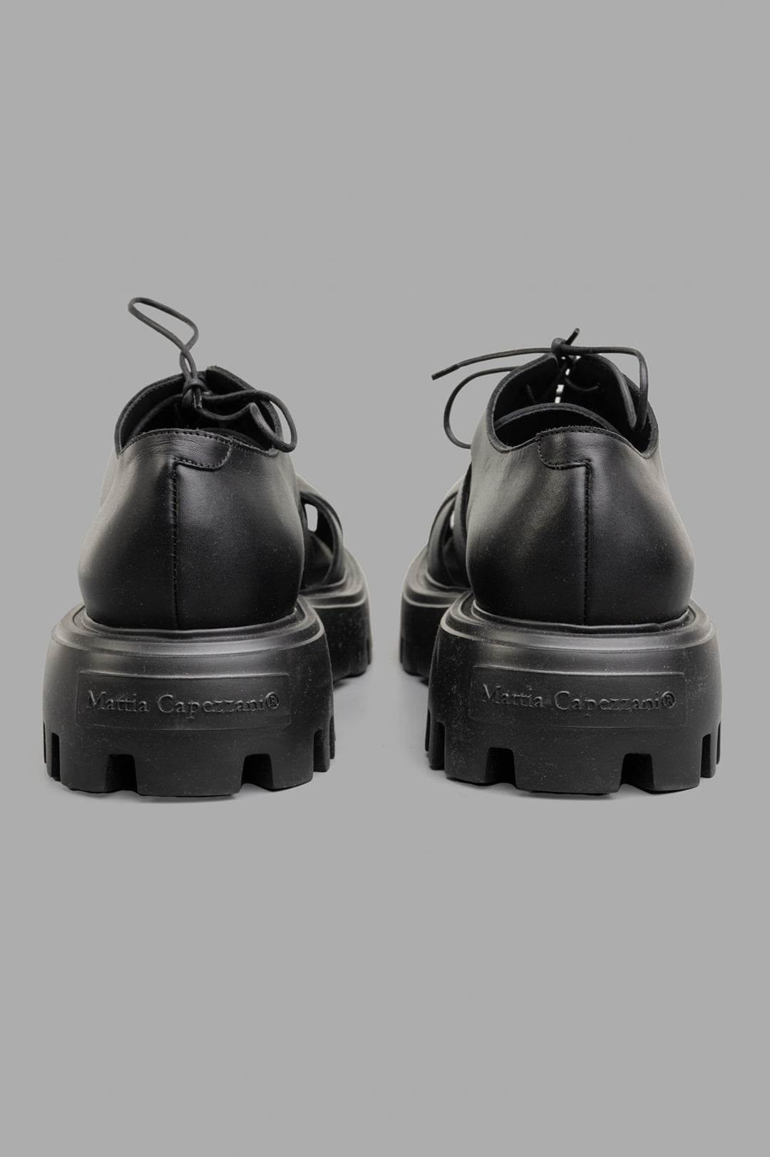 Mattia Capezzani Iron Black Shoes featuring sleek leather design, showcasing sturdy rubber soles and stylish lacing details.