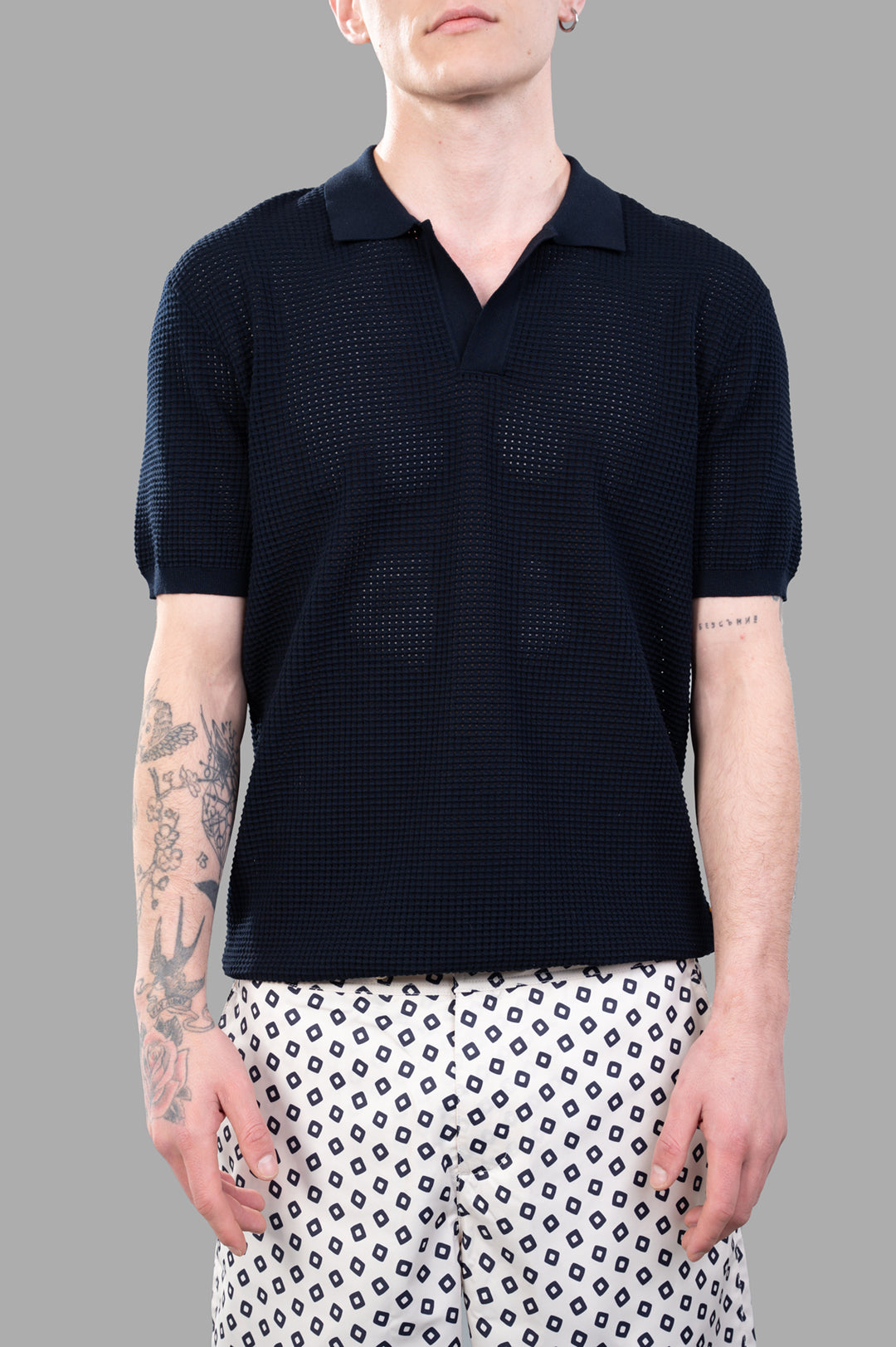 Orlebar Brown Waffle Mesh Polo Shirt in Night Iris, highlighting the back view and breathable material on the model.