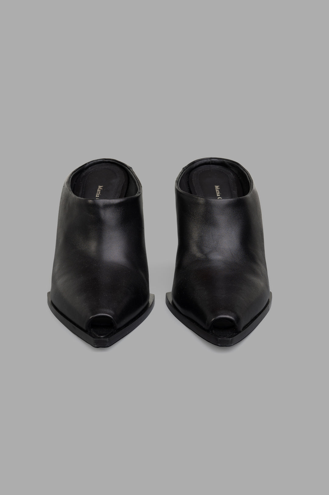 Mattia Capezzani Wedge Mules in black leather, showcasing an open-toe design and sculptural shape from a top view.