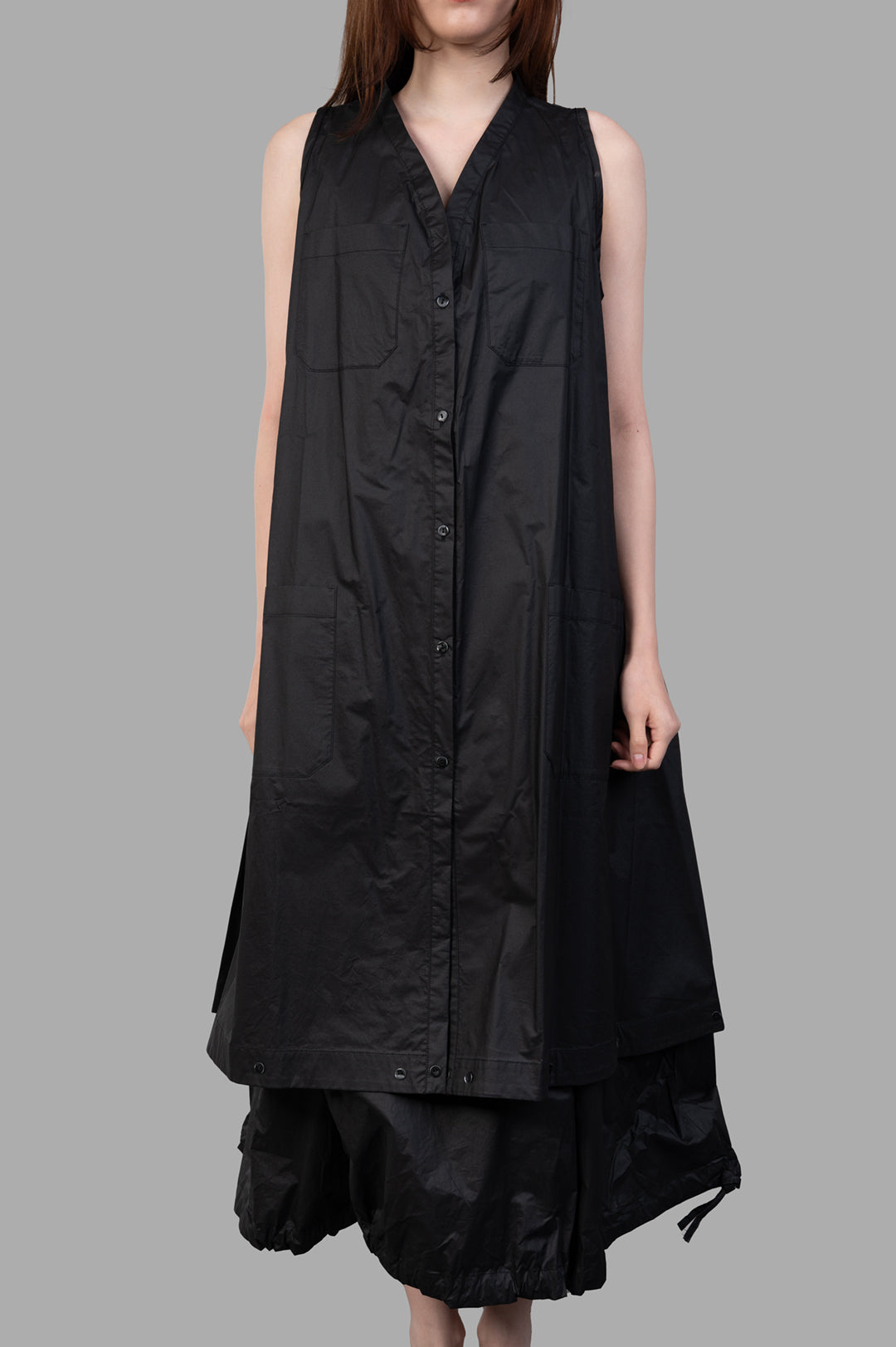 Masnada 2-in-1 Parka on-model front view, black sleeveless button-front style with V-neck and patch pockets, layered hem.