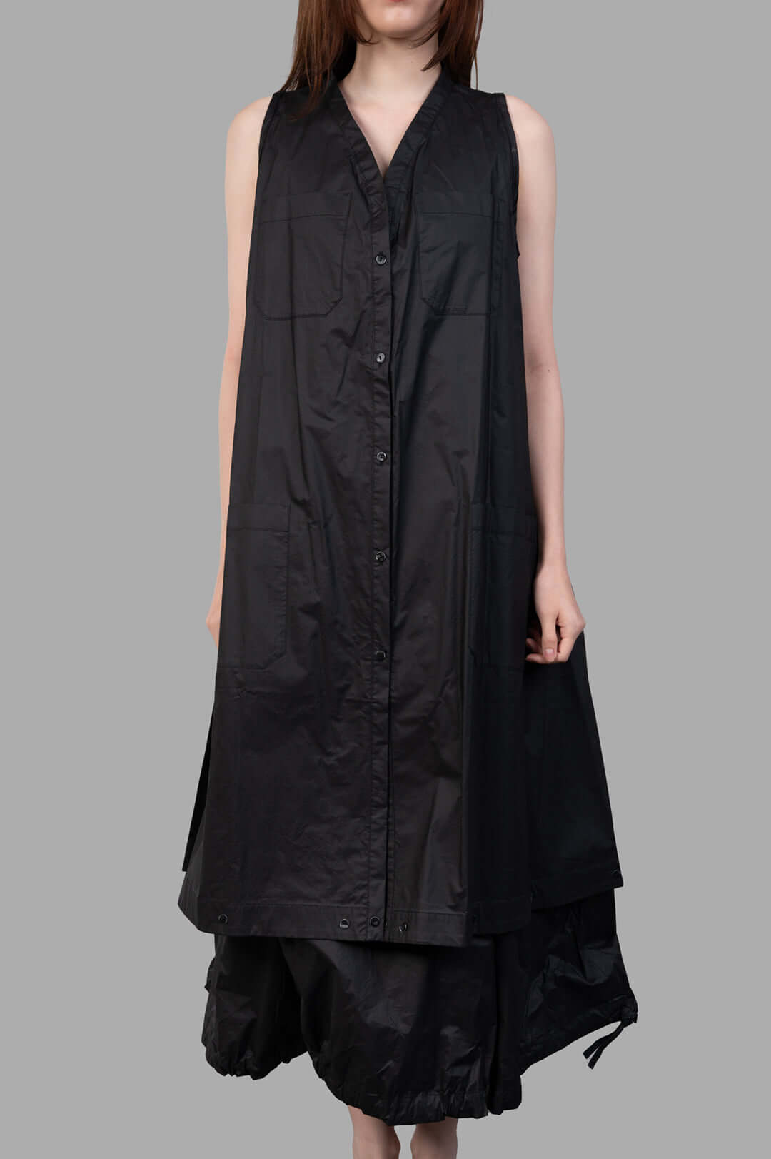 Masnada 2-in-1 Parka on-model front view, black sleeveless button-front style with V-neck and patch pockets, layered hem.