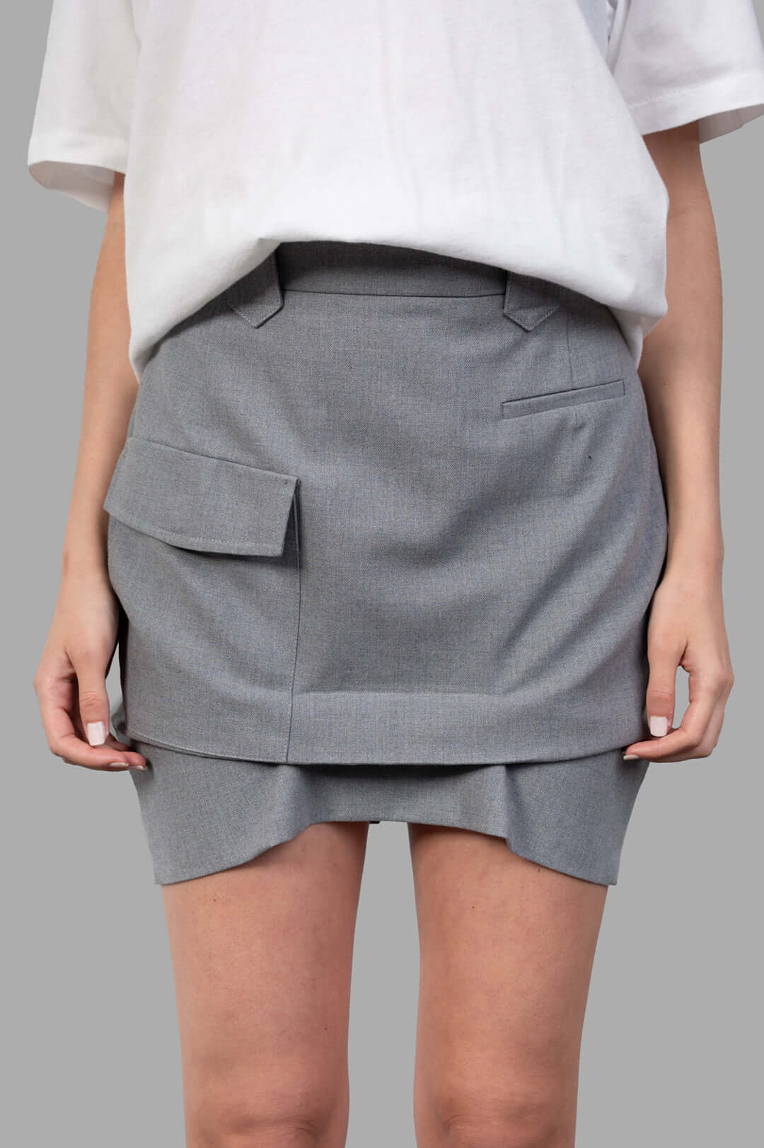 Vivienne Westwood Pleated Cargo Mini Skirt in grey, featuring dual closures and functional side pockets displayed on model.