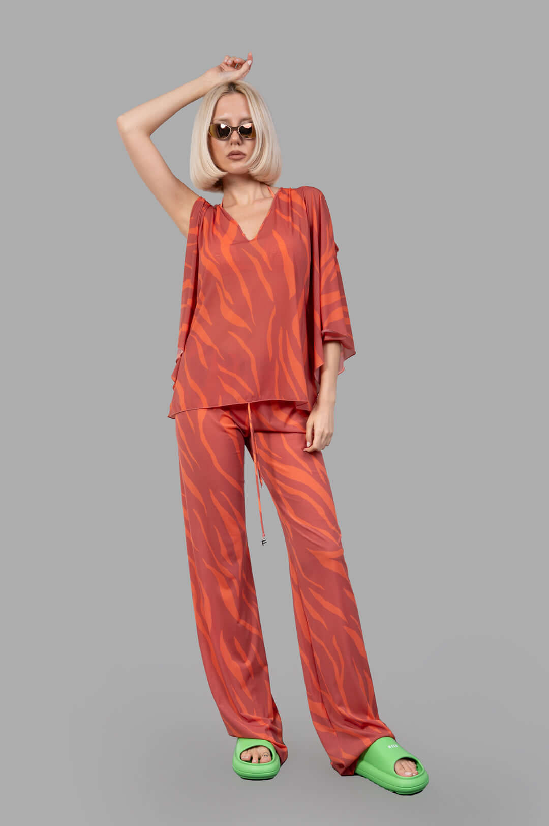 Fisico Zebra-print Top in coral with flowing sleeves, front view on model, showcasing bold, luxurious fabric style.