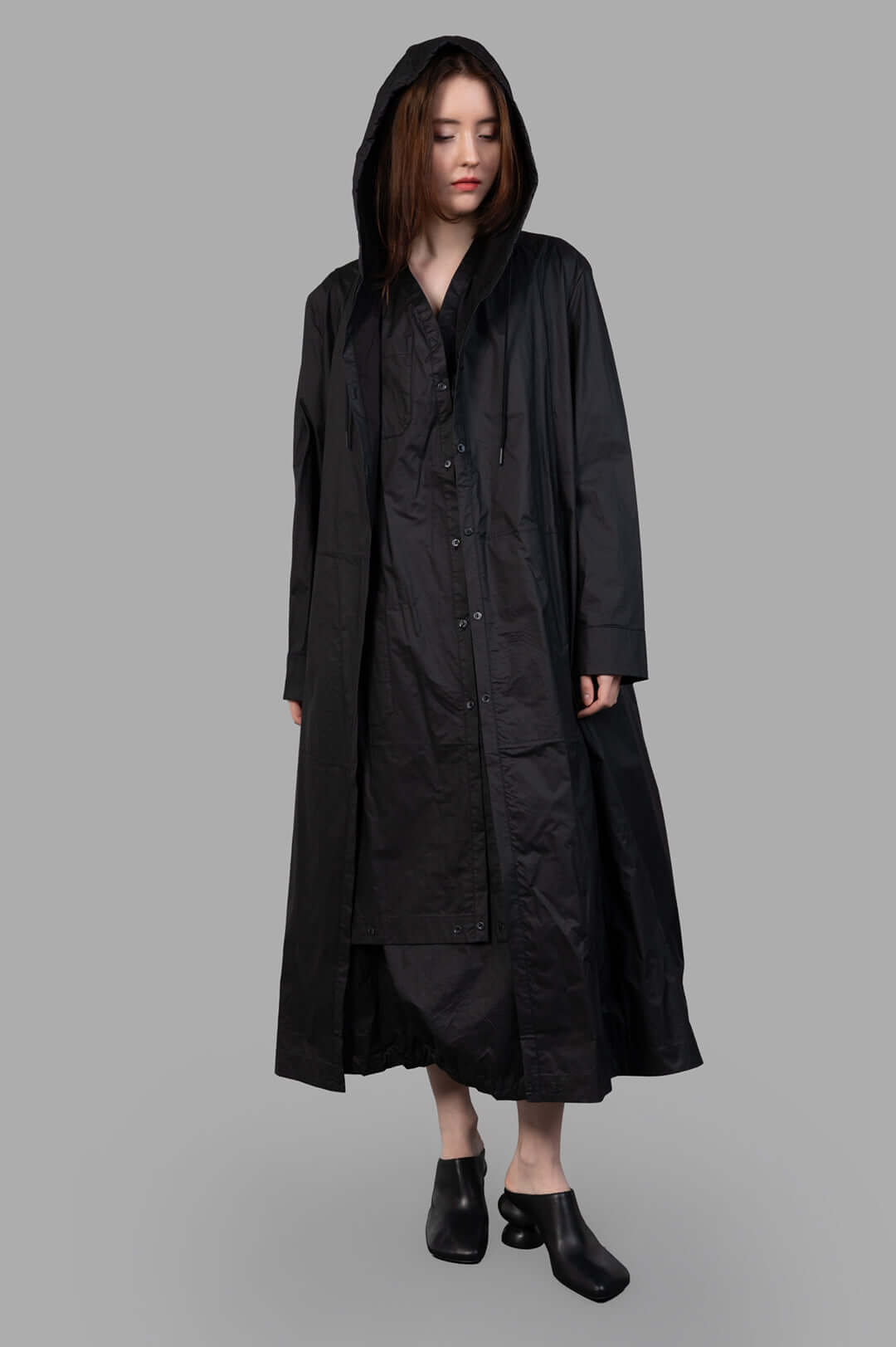 Masnada 2-in-1 Parka, black hooded long coat, front view on-model, button-front with drawstrings, ankle-length