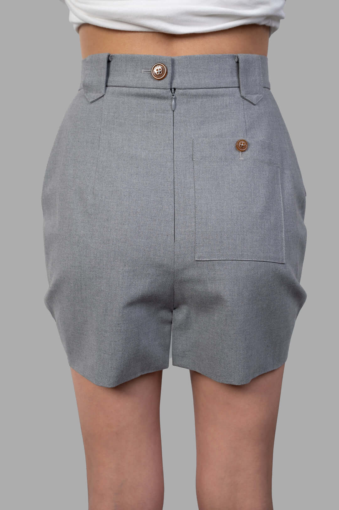 Vivienne Westwood Pleated Cargo Mini Skirt showcased from the back, featuring button and zip closure, grey cotton fabric.