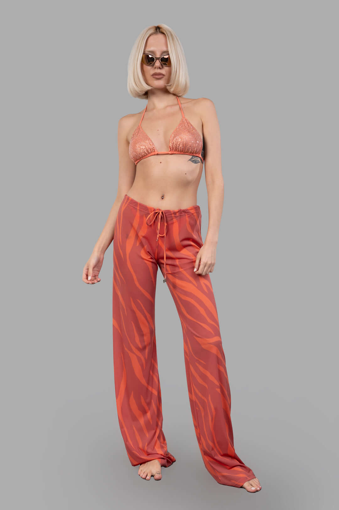 Fisico Zebra-print Trousers in coral, side view on model, featuring a bold, luxurious pattern and impeccable cut.