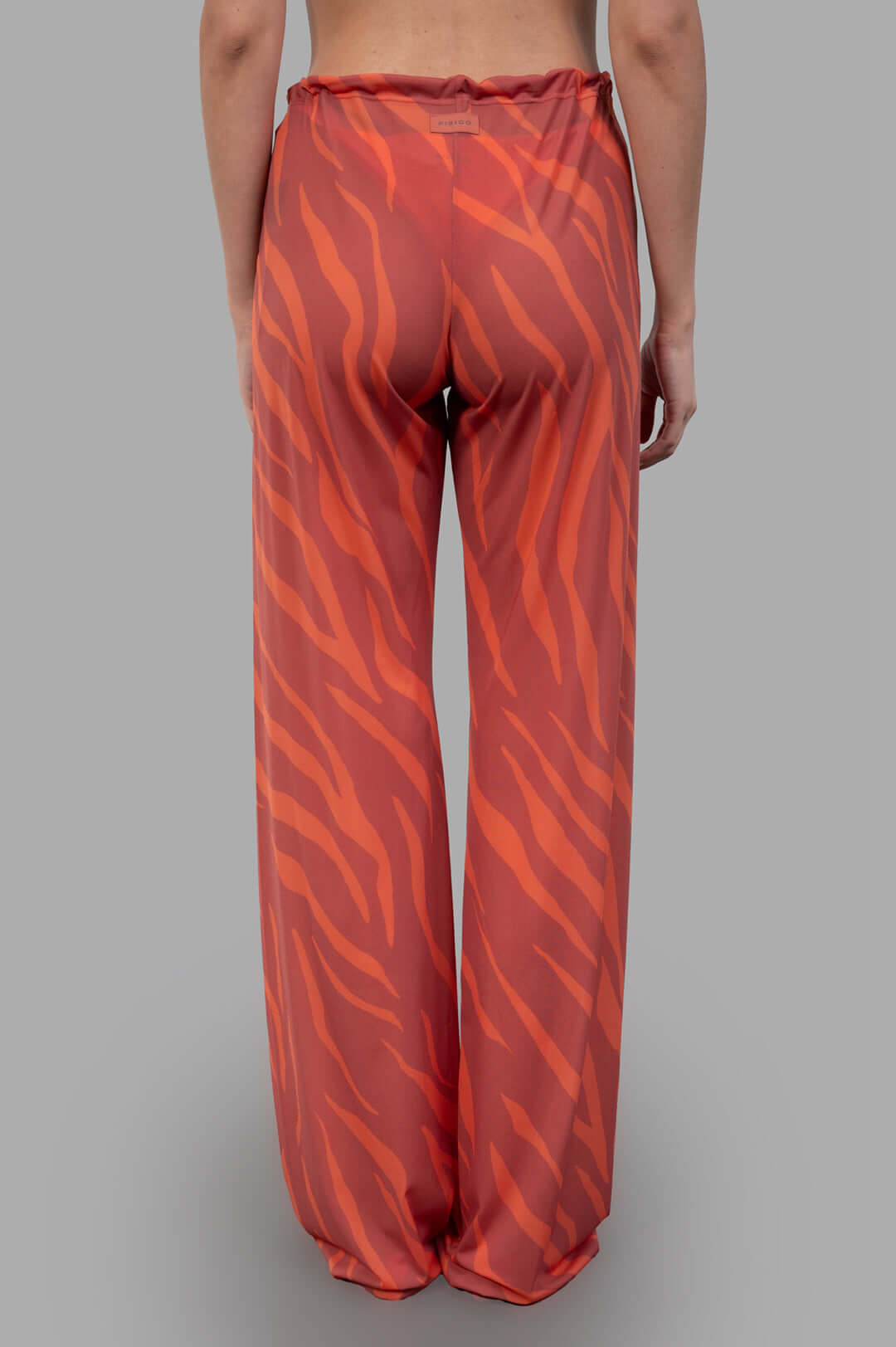 Fisico Zebra-print Trousers showcased from the back, featuring vibrant coral and orange hues with a relaxed fit.