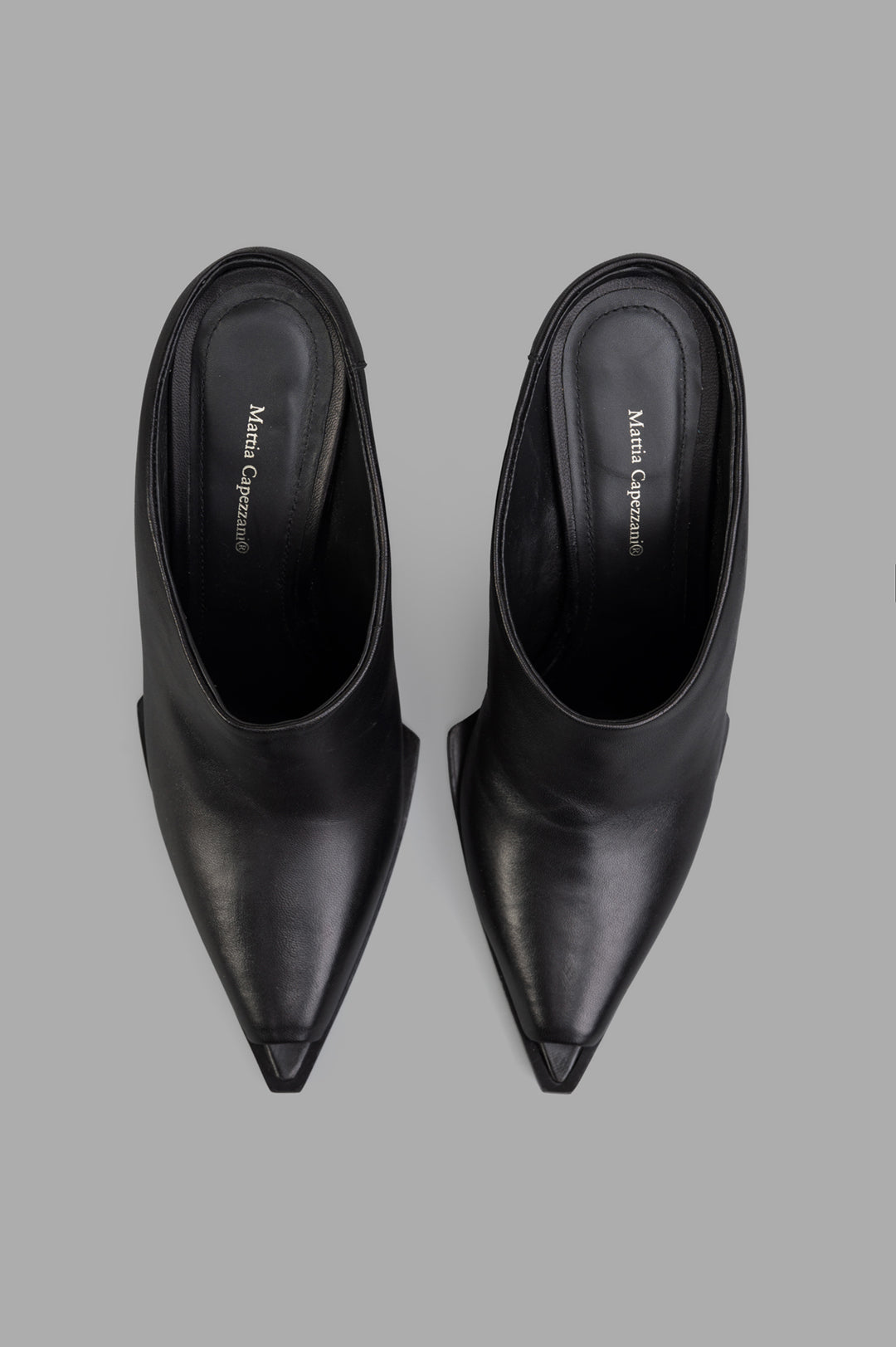 Mattia Capezzani Wedge Mules in black leather, showcasing a sleek, pointed toe and elegant curved lines from above.
