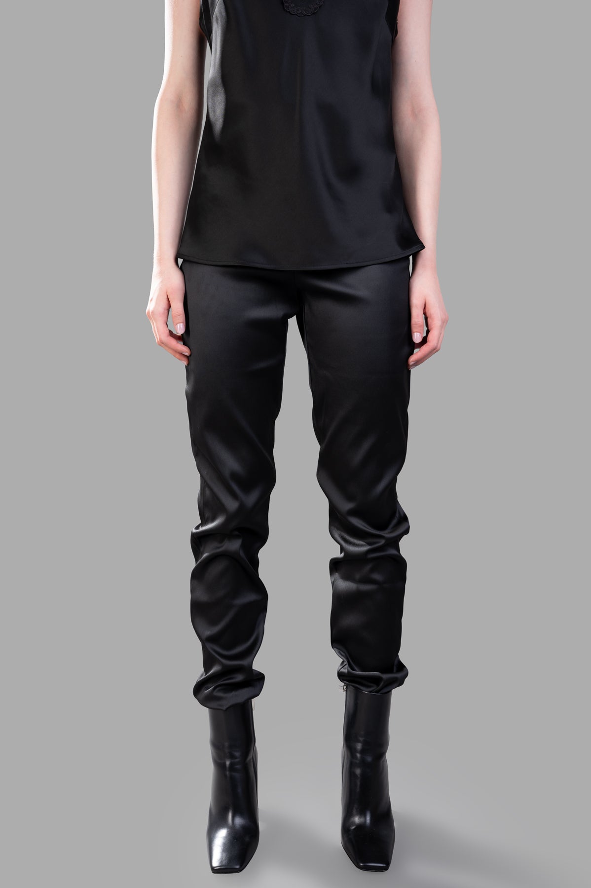 Giovanni Cavagna Satin Trousers feature a high-waisted design, showcased on-model for a sleek, refined look.