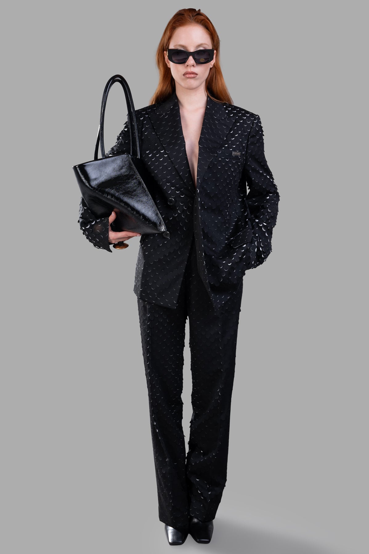 Helmut Lang Hole-Punched Car Blazer in black, front view on model, shows laser-cut texture and relaxed fit.
