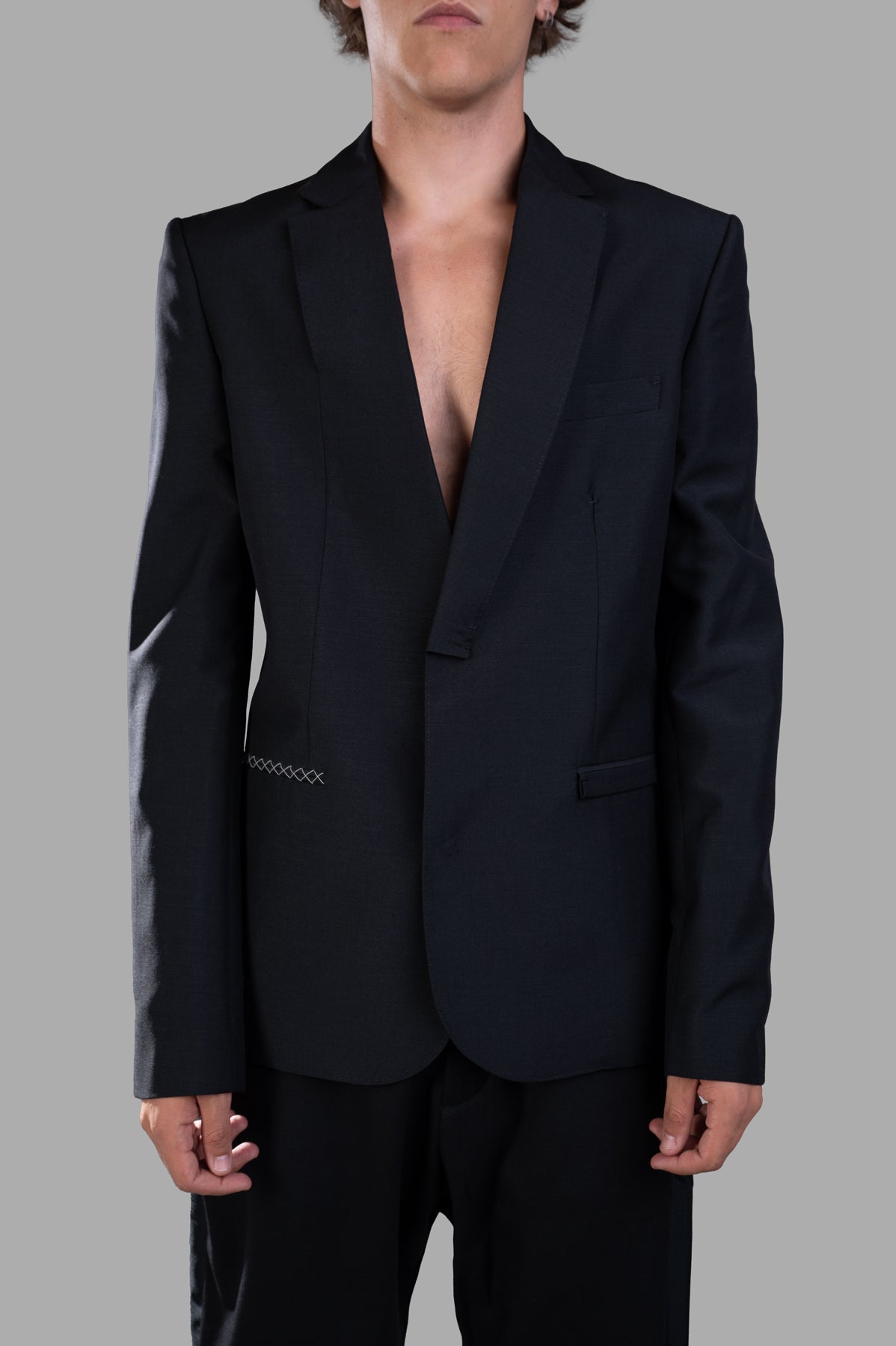 Giovanni Cavagna Structured Blazer in black, showcasing a single-breasted design and contrast stitching on a model.