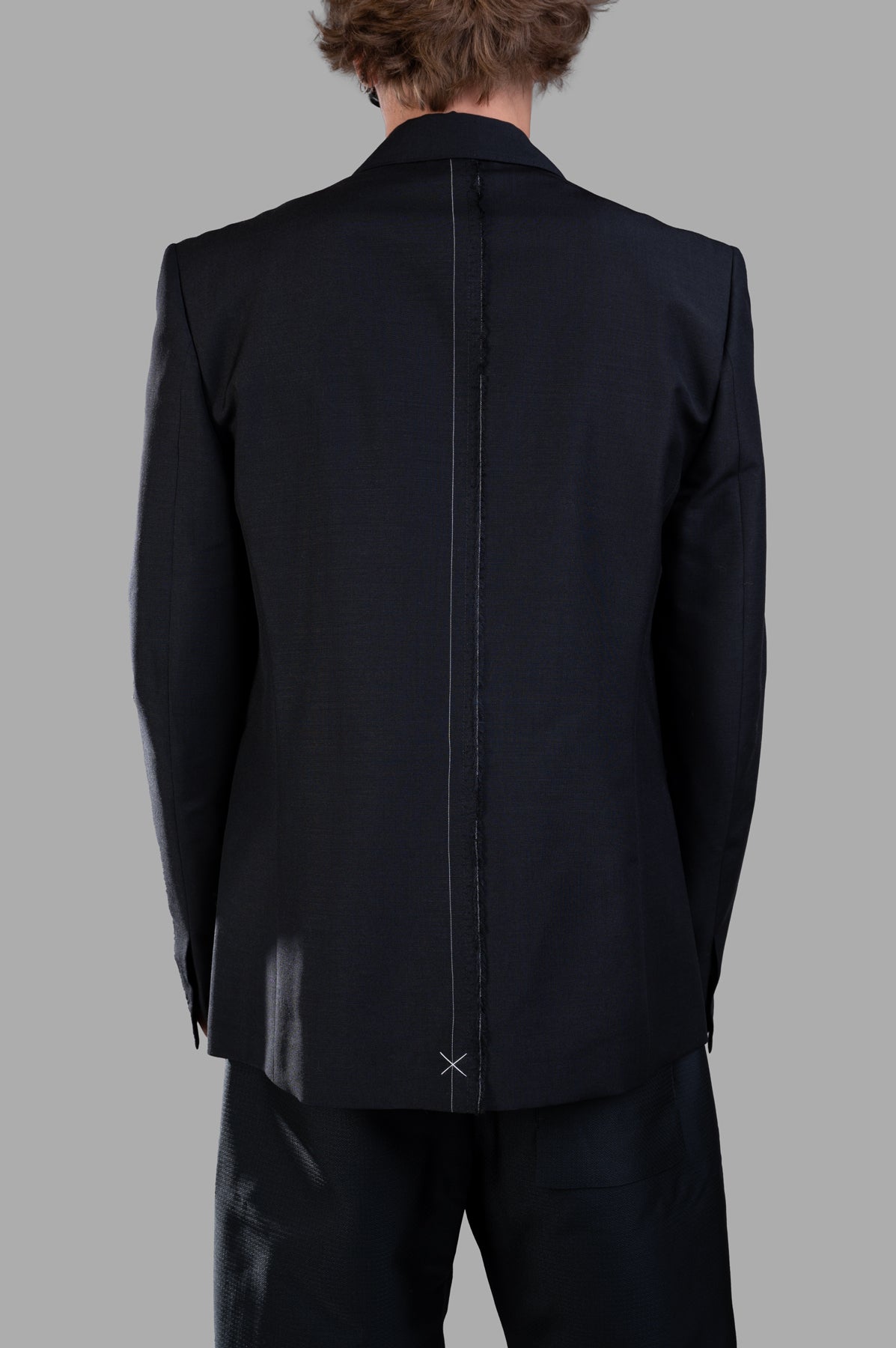 Giovanni Cavagna Structured Blazer showcasing the back view with contrast stitching, tailored black wool fabric detail.