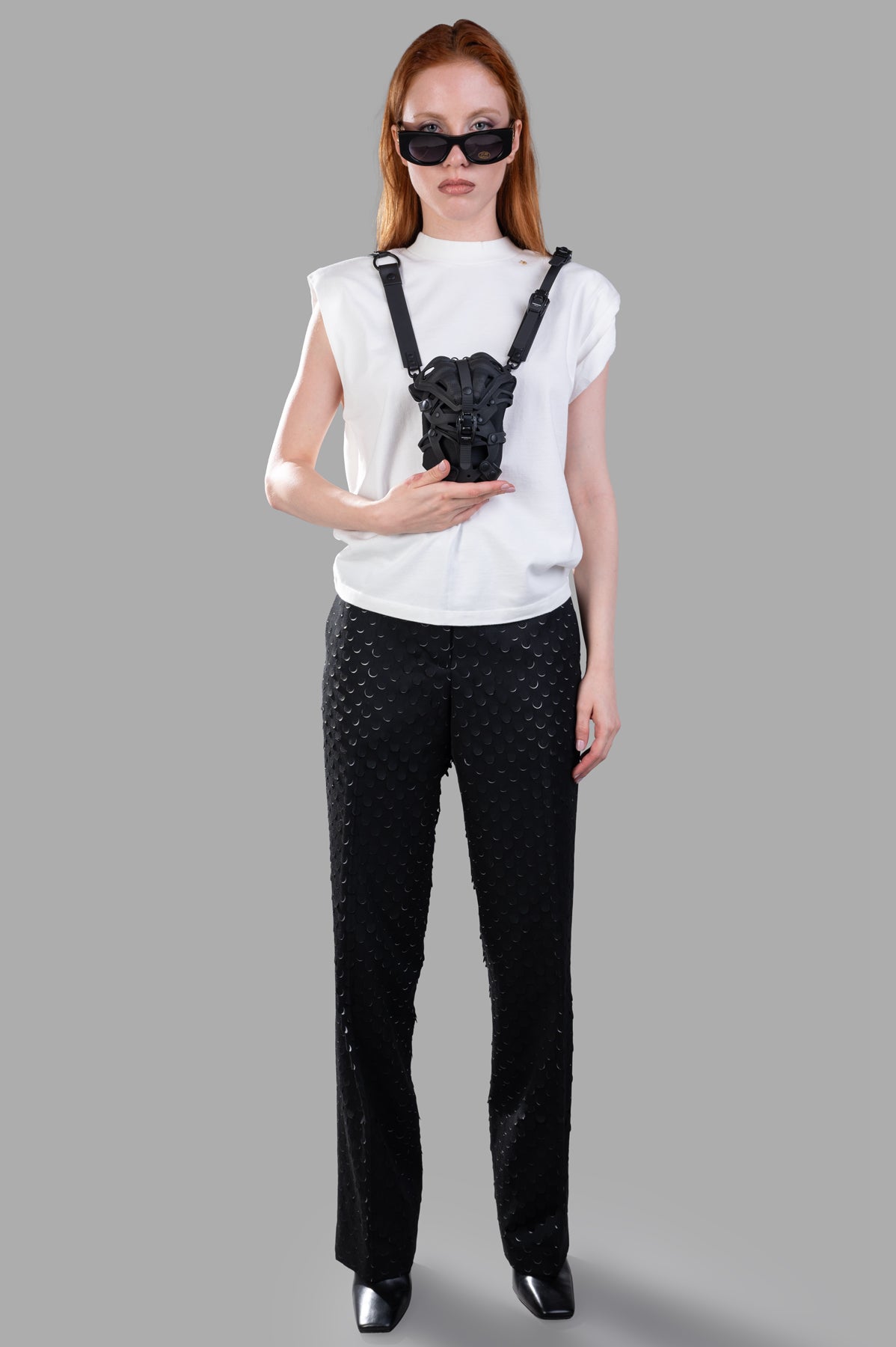 Helmut Lang Hole-Punched Car Trousers showcase frontal view with textured, relaxed fit, black polyester-rayon fabric.