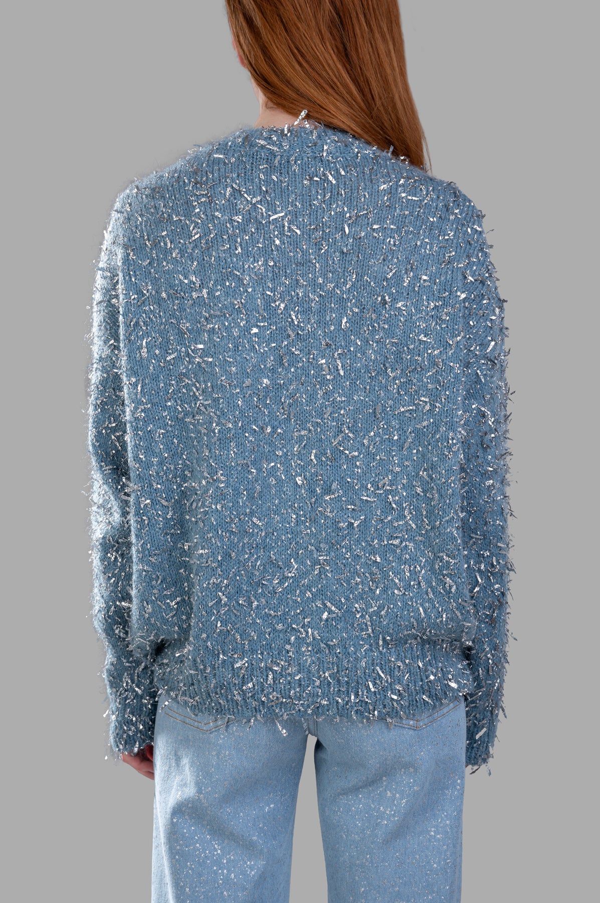 MSGM Lamé Thread Sweater, back view showcasing frayed silver ribbon textures on luxurious blue wool blend fabric.