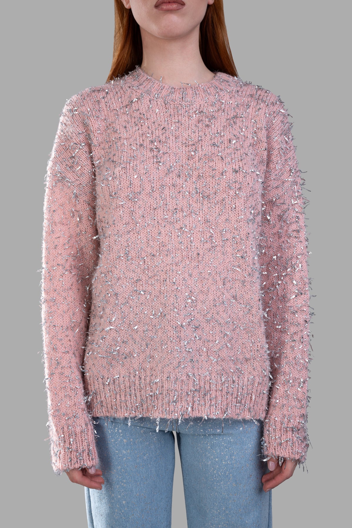 MSGM Lamé Thread Sweater featuring a pink color, ribbed details, and sparkling silver ribbon weaves, on a model.