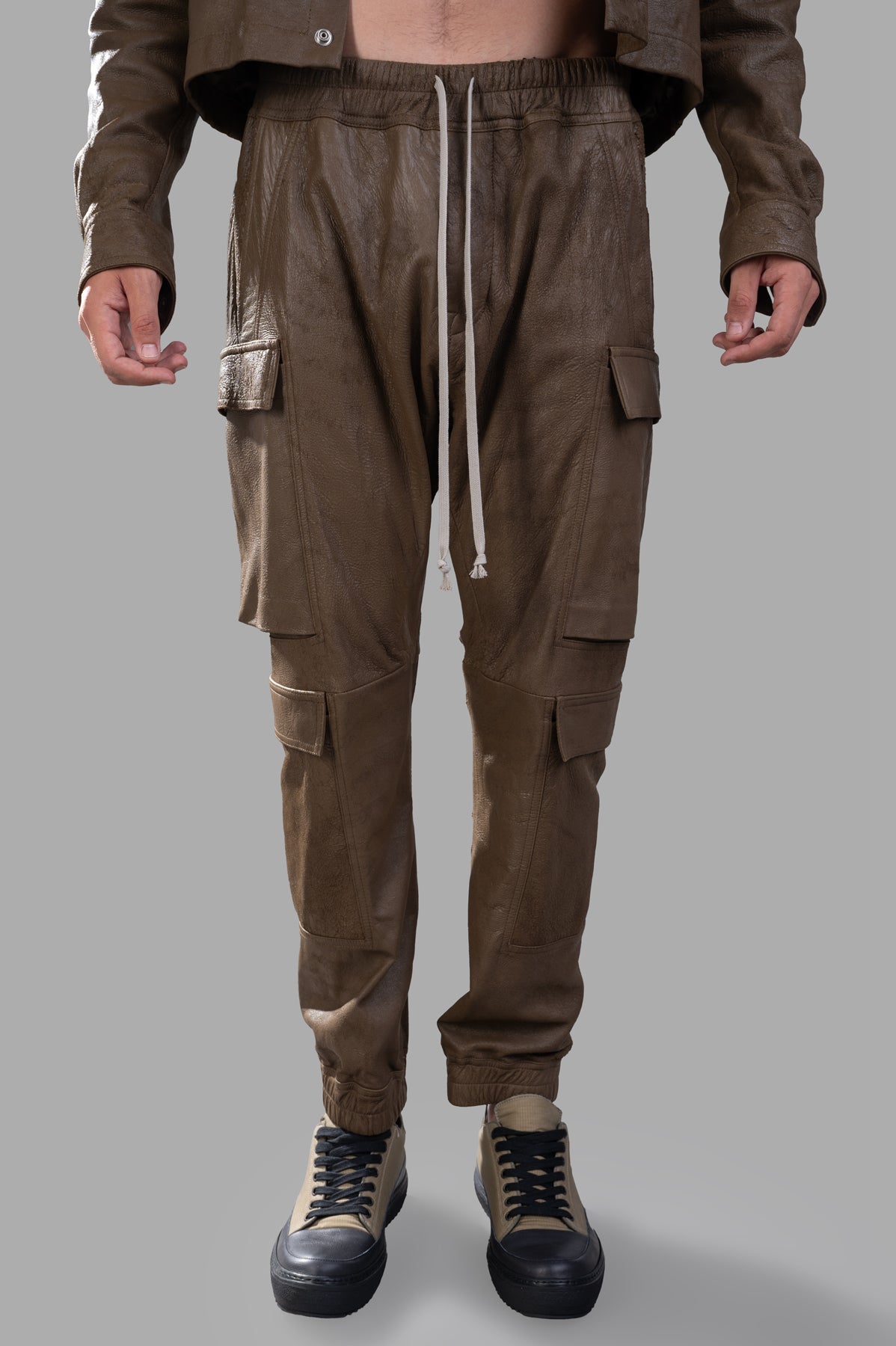 Rick Owens Porterville Mastodon Pants showcased in green lamb leather, featuring cargo pockets, elastic waist, and a slim.