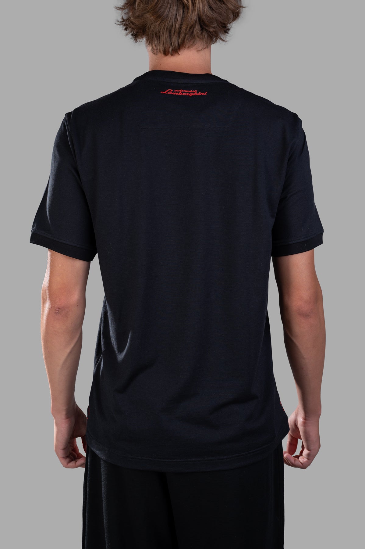 Orlebar Brown 'Lamborghini' Logo T-shirt, back view on-model; black tee with red logo at neck.