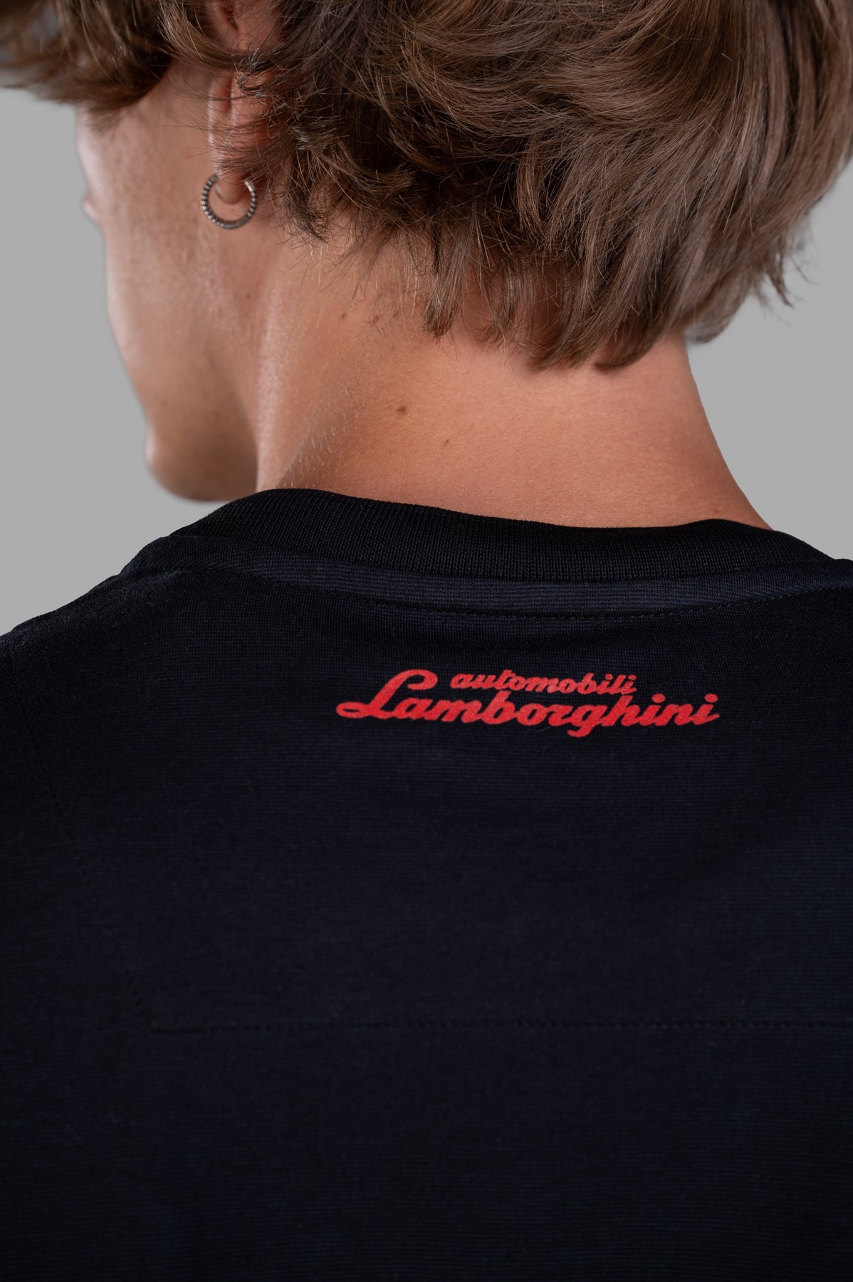 Orlebar Brown 'Lamborghini' Logo T-shirt, back detail on-model; red Automobili Lamborghini print at neck on black tee.