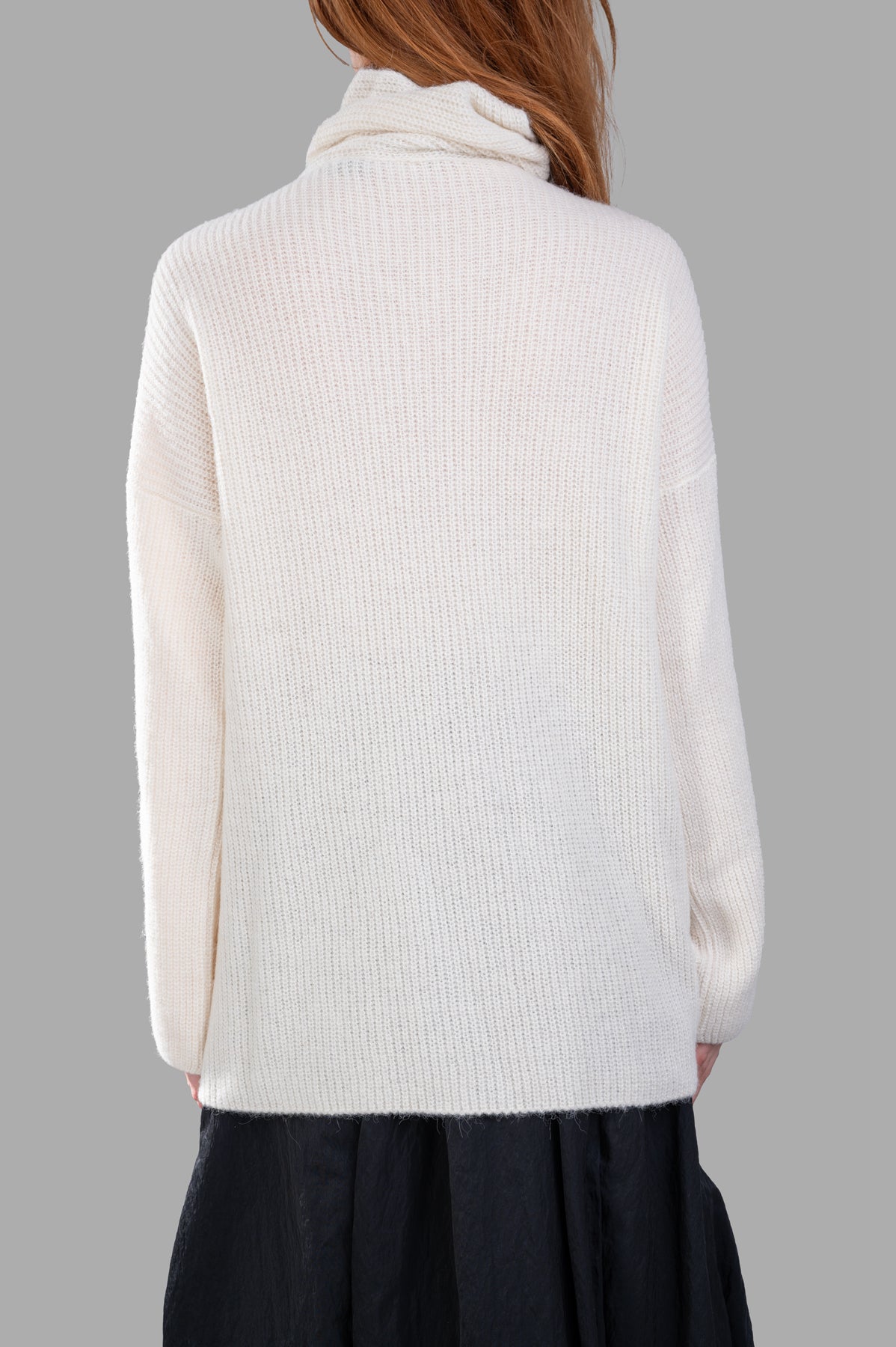 Gentry Portofino Cream Sweater with cozy asymmetric turtleneck, showcased from the back in soft knit fabric.