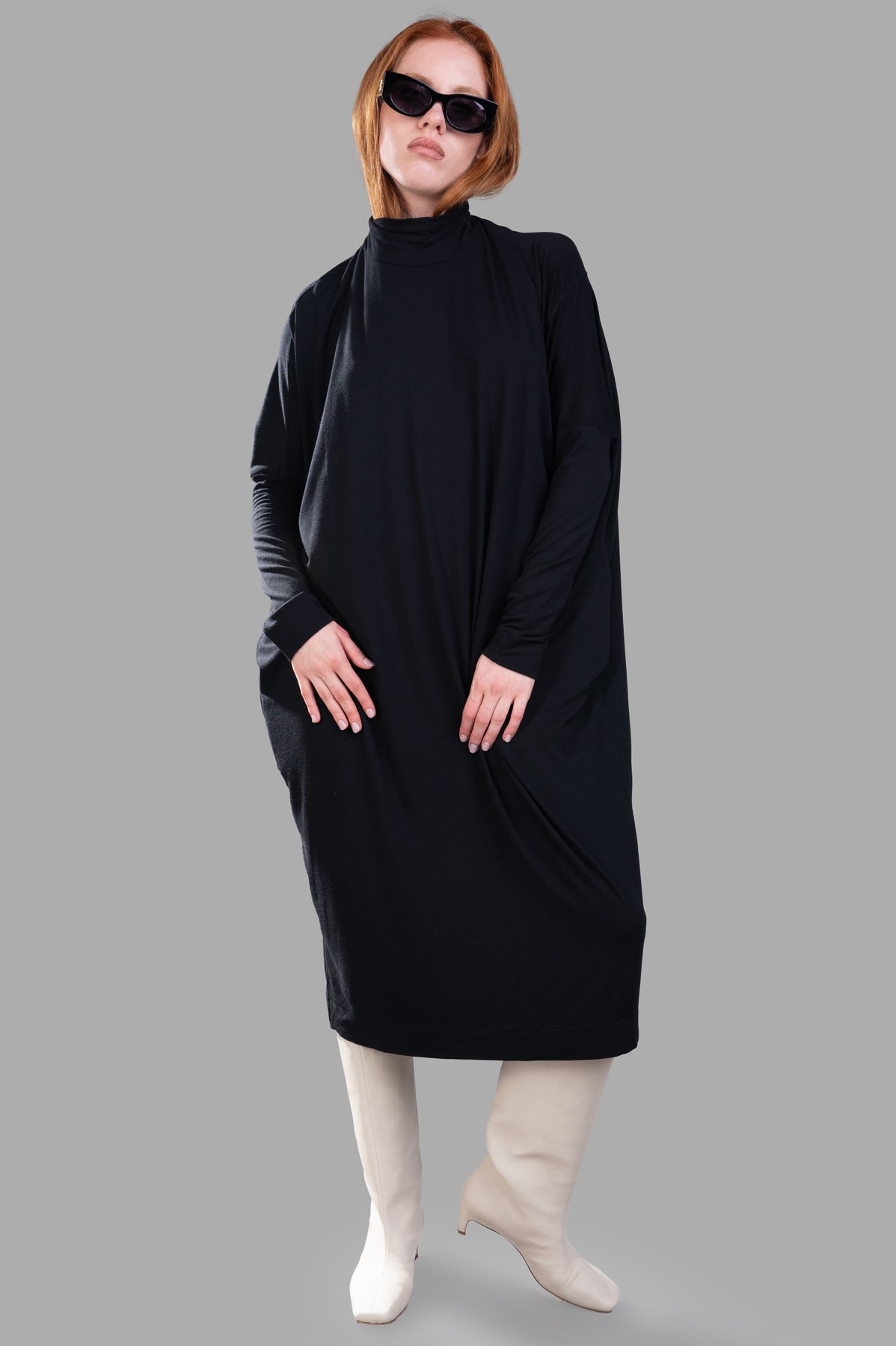Gentry Portofino oversized midi dress, front view, in black with turtleneck and balloon silhouette, on-model.
