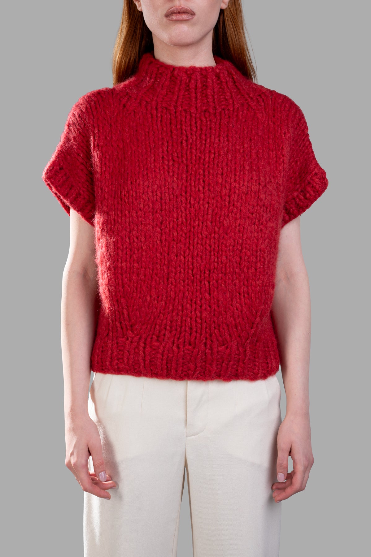 Gentry Portofino Chunky Knit Vest in red featuring cozy cap sleeves, round neckline, and soft wool-cashmere blend texture.