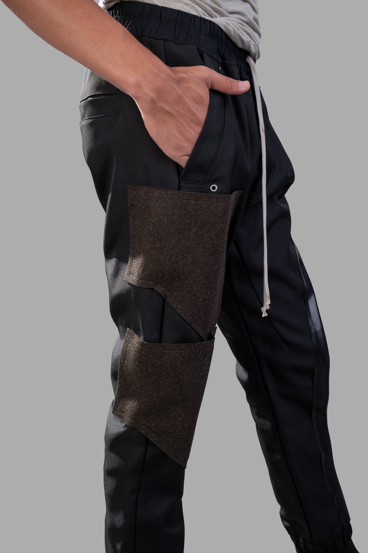 Rick Owens Porterville Mastodon Megacargo Pants feature detailed cargo pockets and a slim fit with an elastic waistband, on.