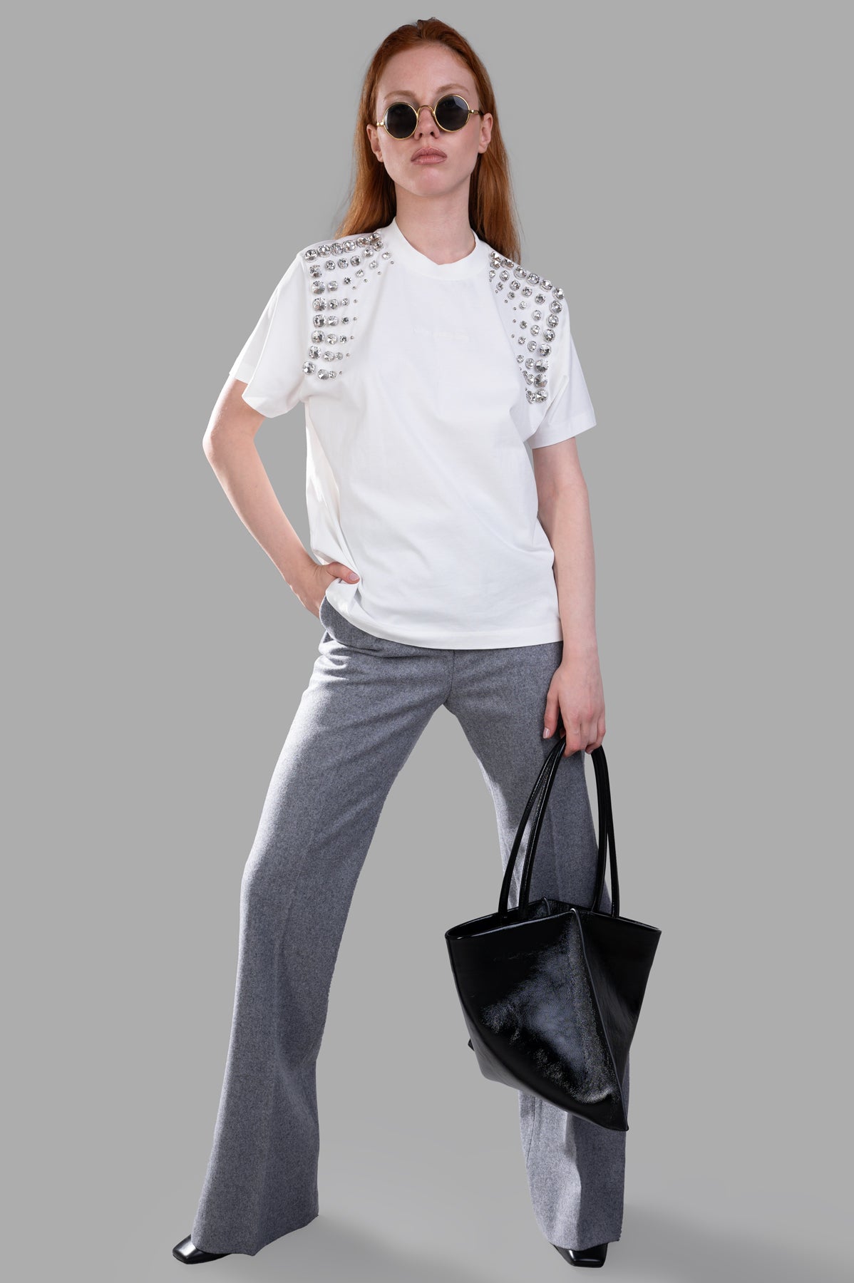 MSGM grey wool pants with studs, front view, styled with black bag. Tailored straight-leg fit for elegant occasions.