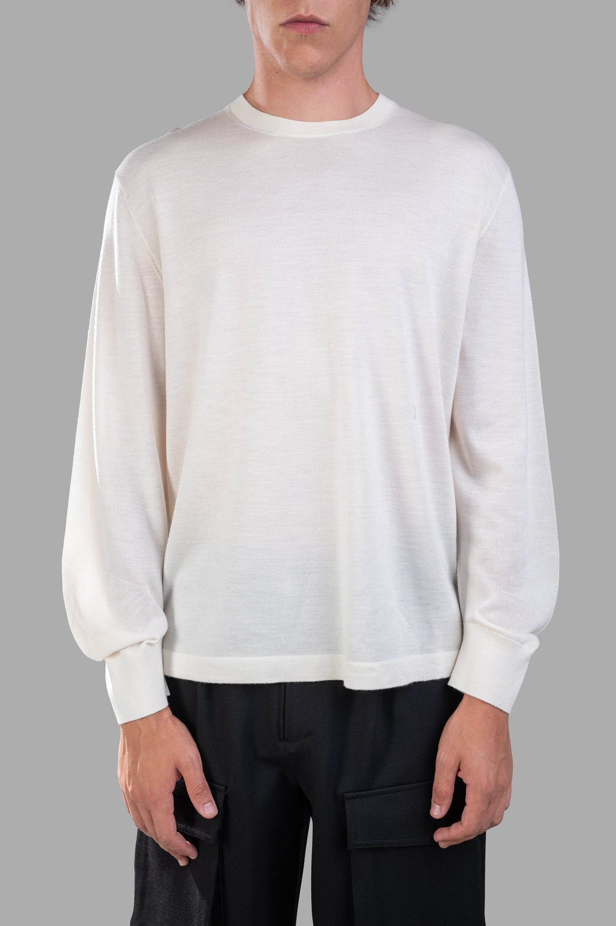 Helmut Lang Curved Sleeve Sweater in ivory, featuring a crew neck and elbow-length sleeves, modeled on a neutral background.