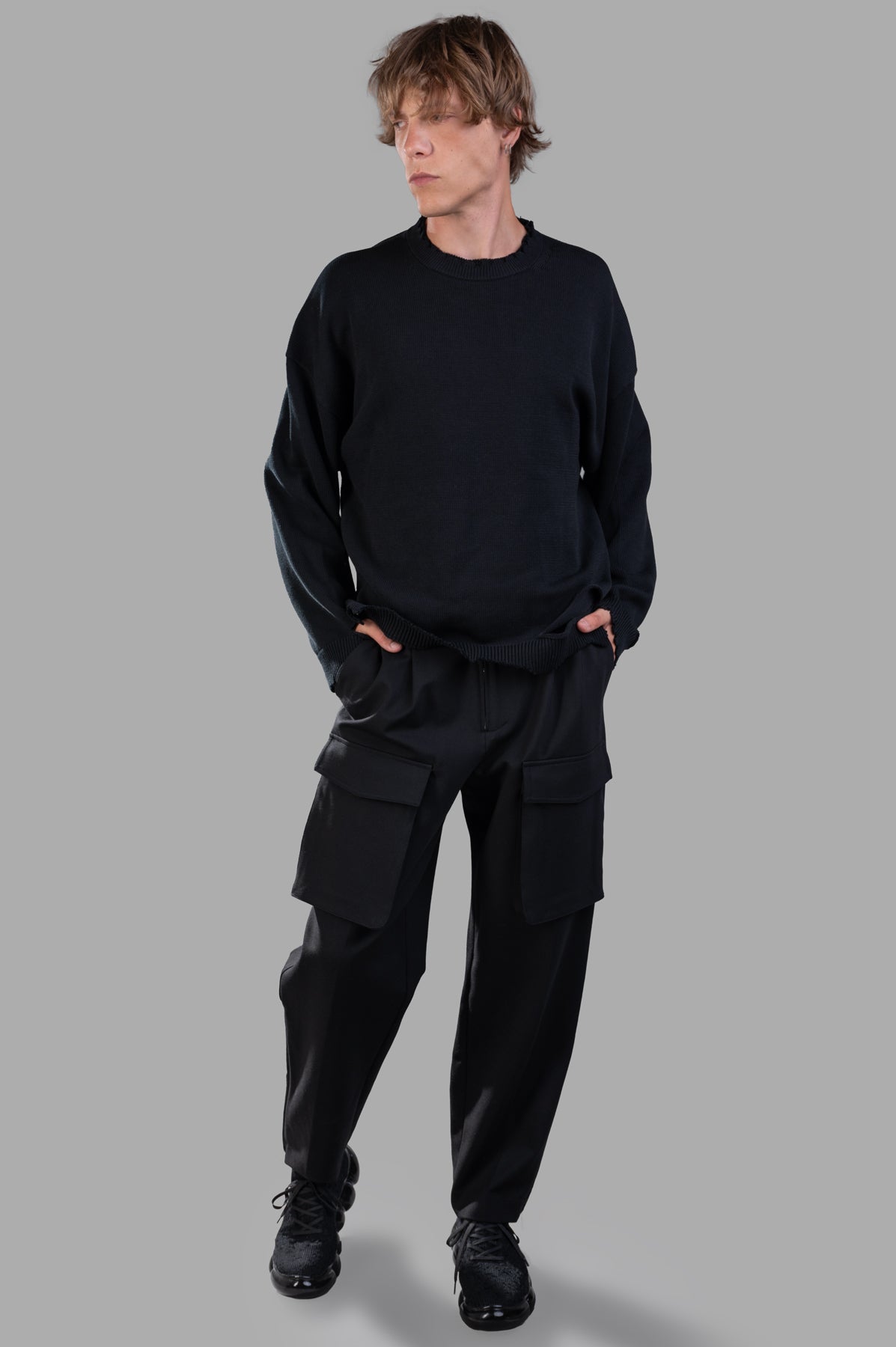 Helmut Lang Pocket Zoot Pants in black with front flap pockets, shown on-model, featuring a relaxed, carrot shape.