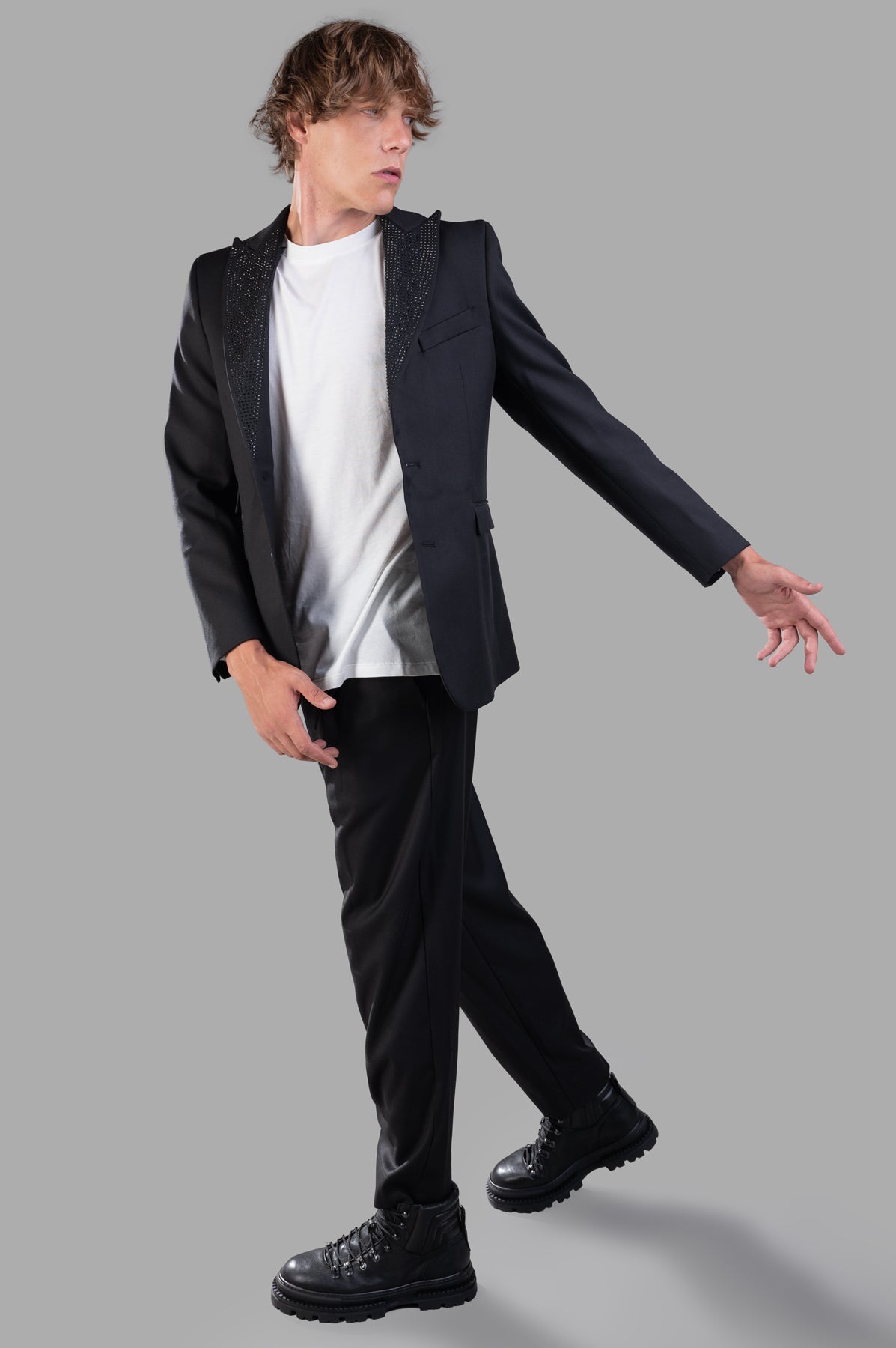 Gaëlle Paris Bedazzled Blazer shown on model, front view with sparkling lapel detail, styled with white shirt and black pants.
