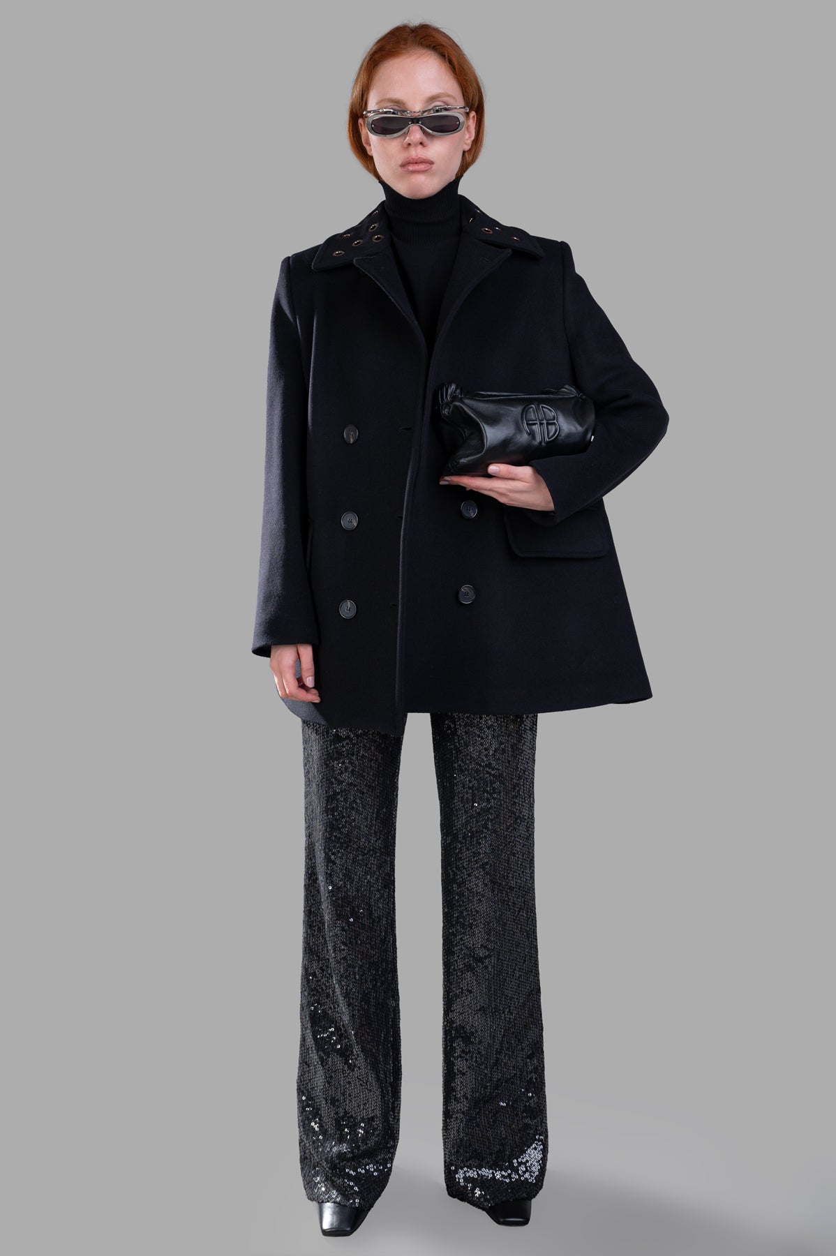 MSGM Double-breasted Coat, black, on-model front view. Features wide lapels, boxy silhouette. Paired with black clutch.