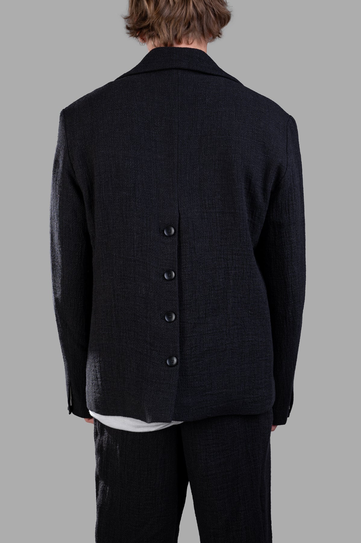 Marc Point Double-breasted Jacket shown from the back, featuring wide lapels and button detail for a stylish look.